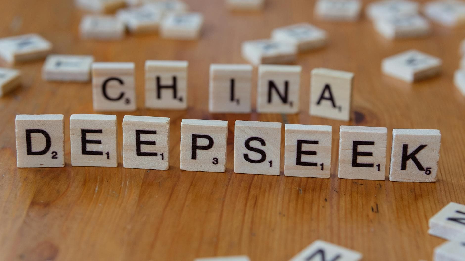 Close-up of wooden Scrabble tiles spelling 'China' and 'Deepseek' on a wooden surface. - love language quiz