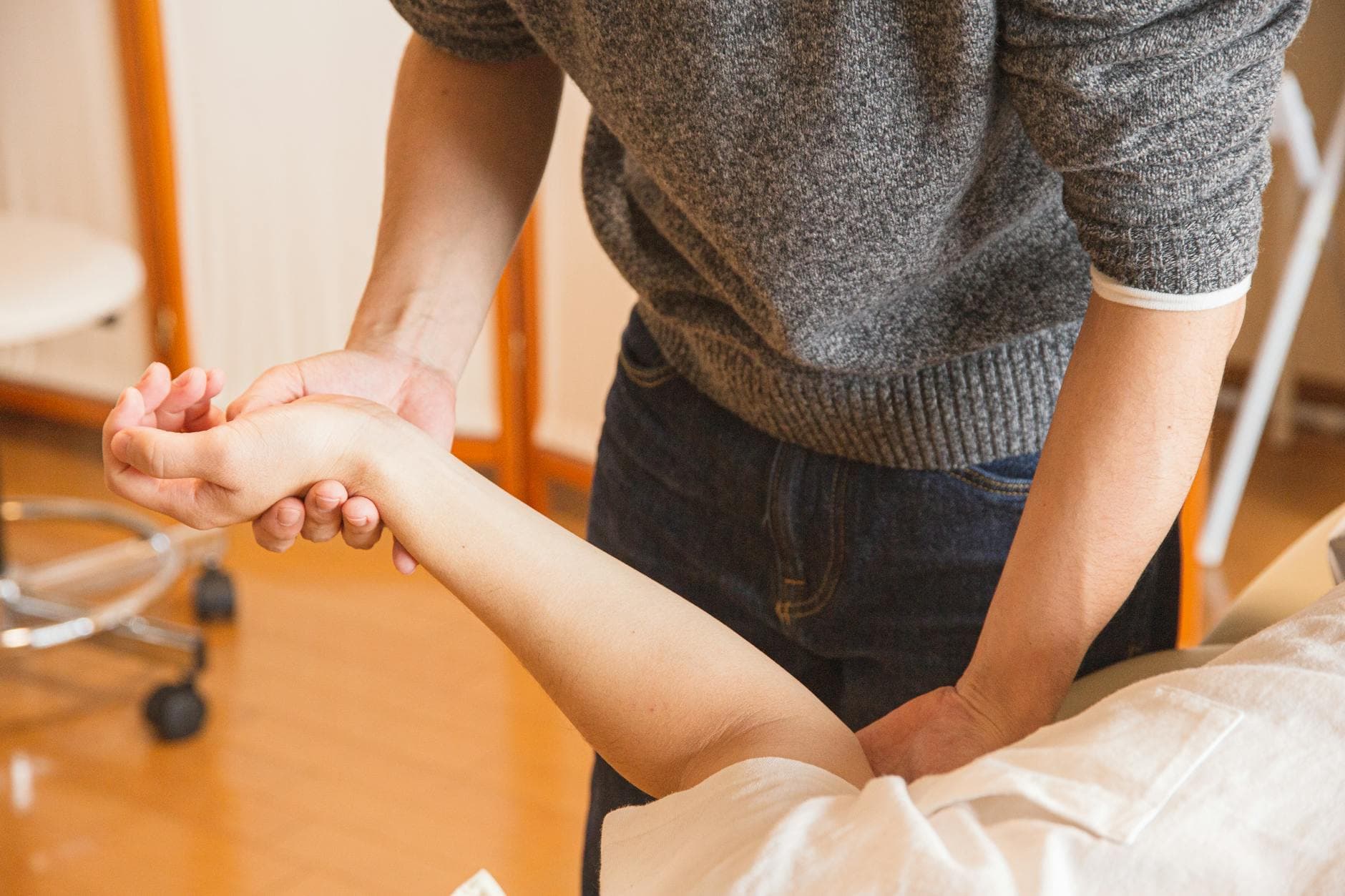 Therapist assisting a patient with wrist therapy. Focus on healthcare and wellness. - couples therapy guide