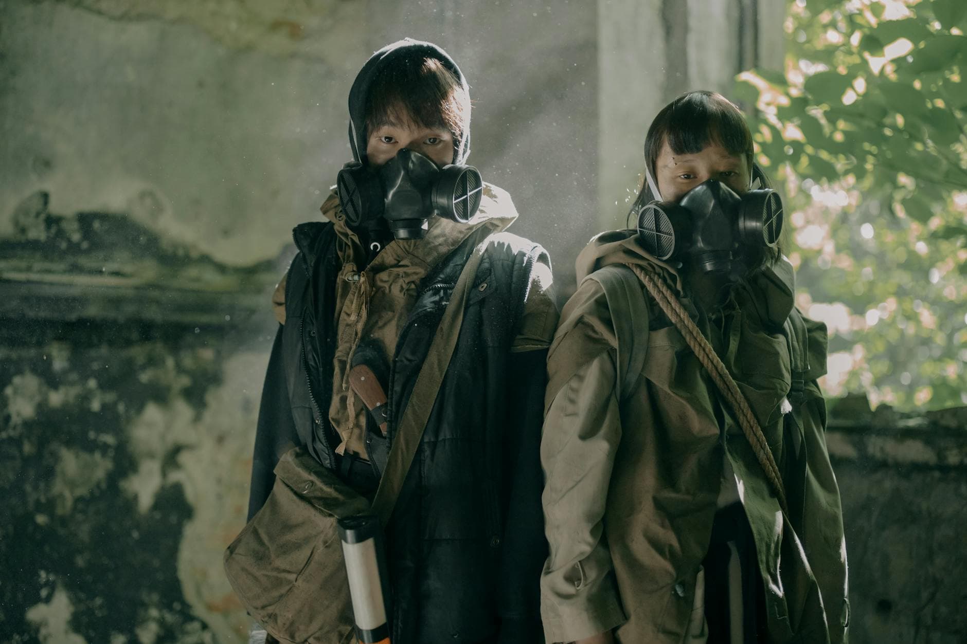 Two people wearing gas masks in a decaying building, illustrating post-apocalyptic survival. - difficult conversations