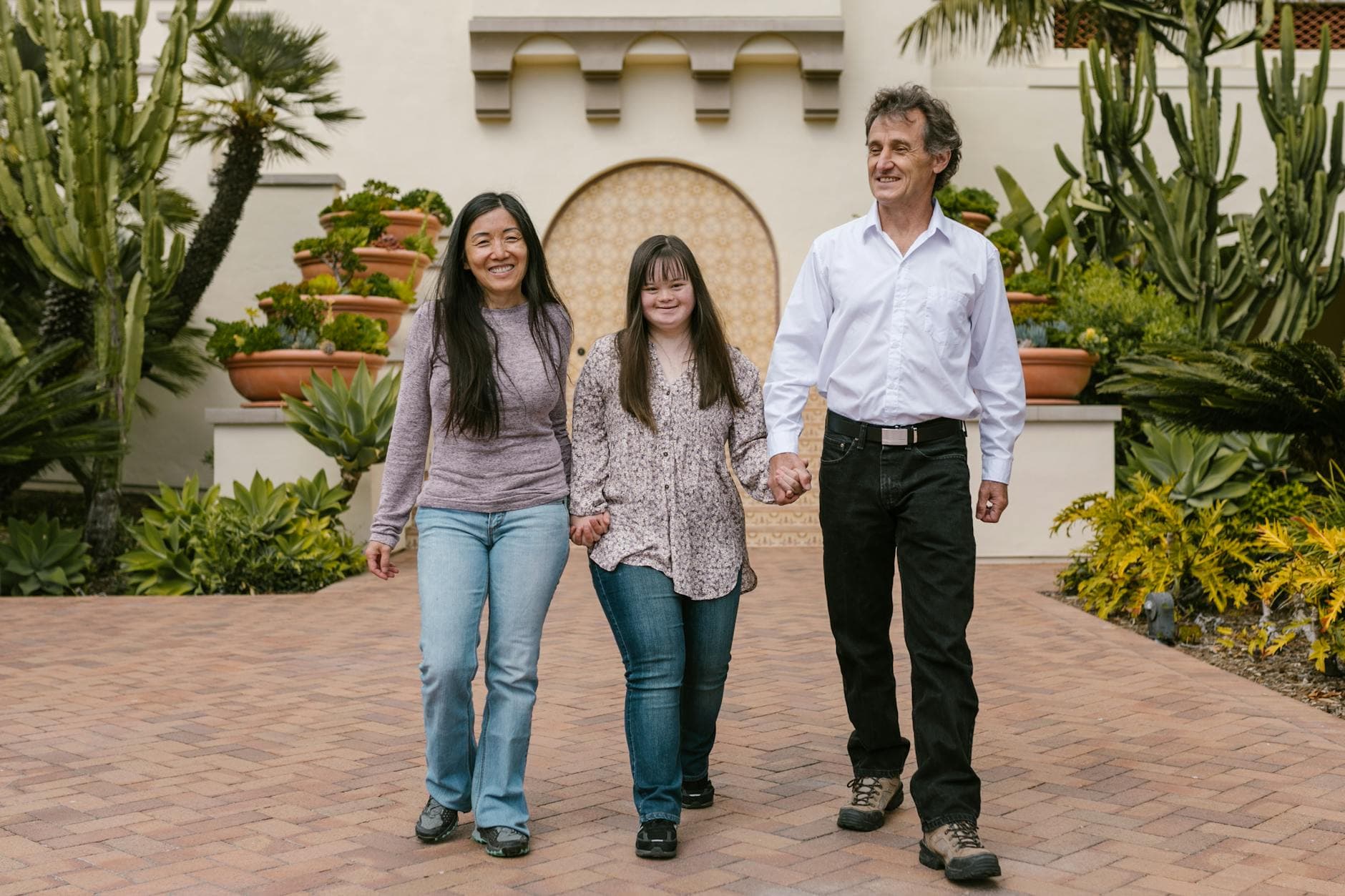 A family enjoys a walk in a beautiful garden, highlighting love and Down syndrome awareness. - express relationship needs