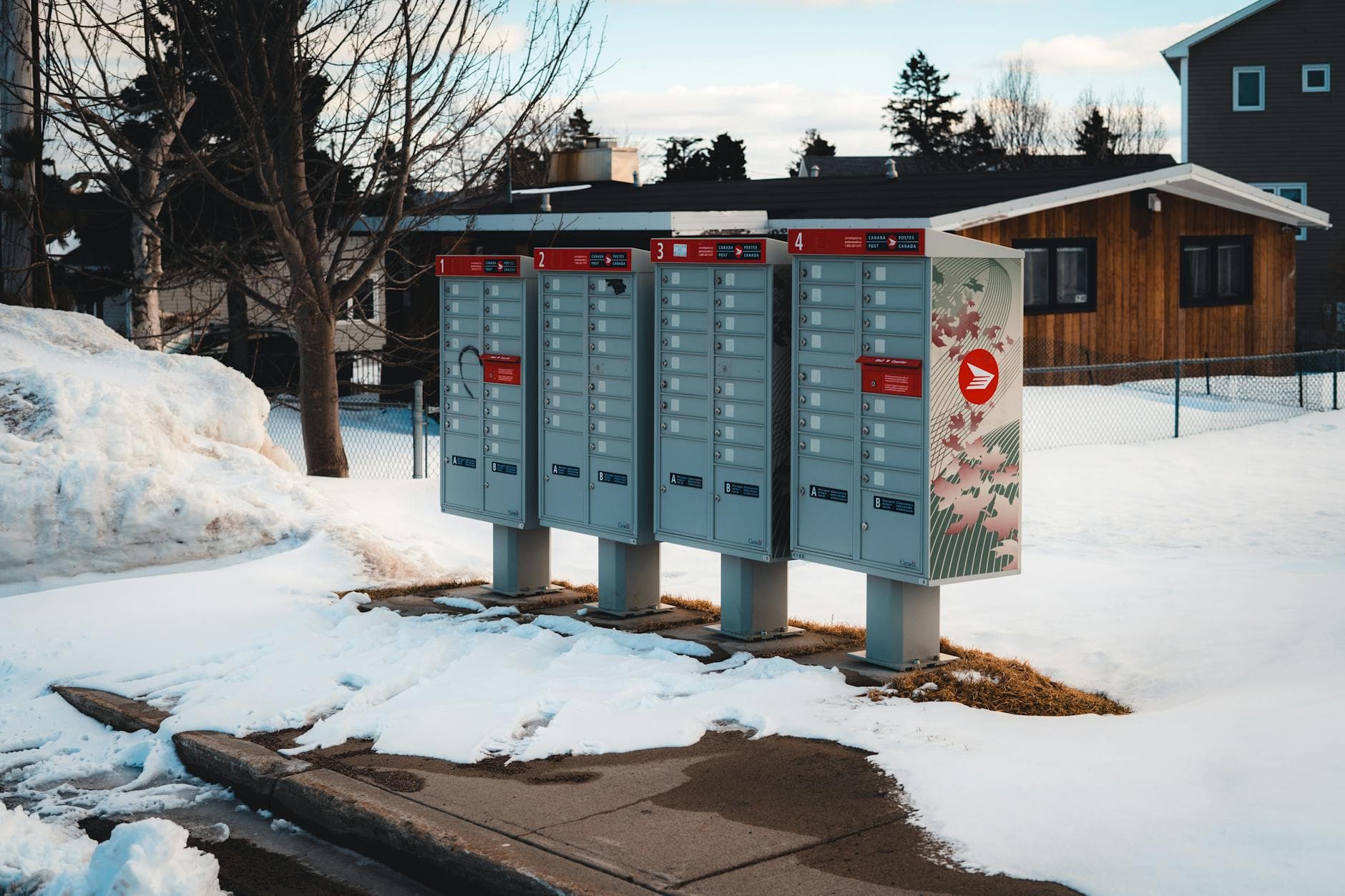 Community mailboxes in a snow-covered suburban neighborhood during winter season. - post winter break routine