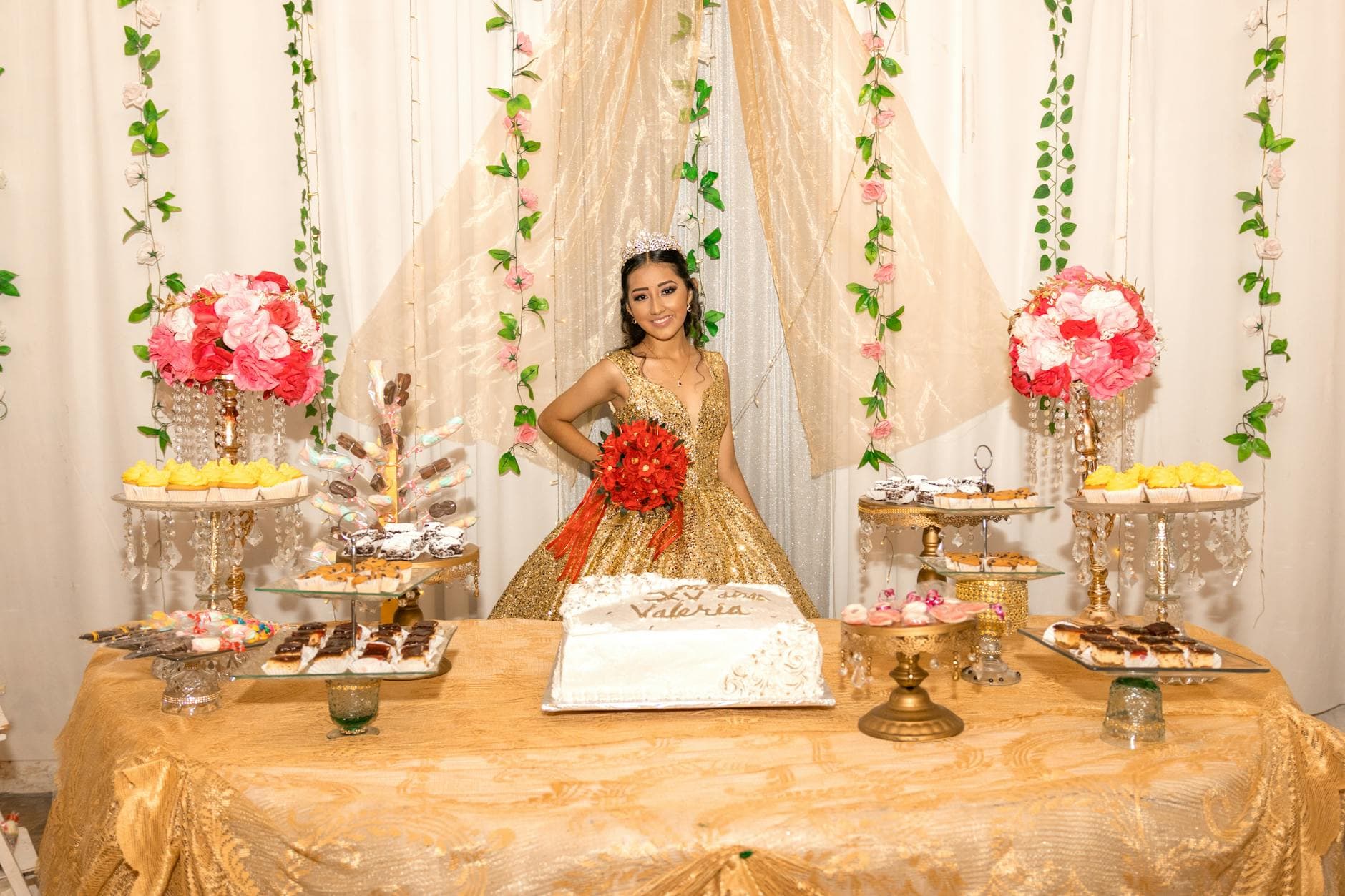 Quinceañera celebration featuring a girl in a golden dress with elegant table decorations and flowers. - teen summer plans