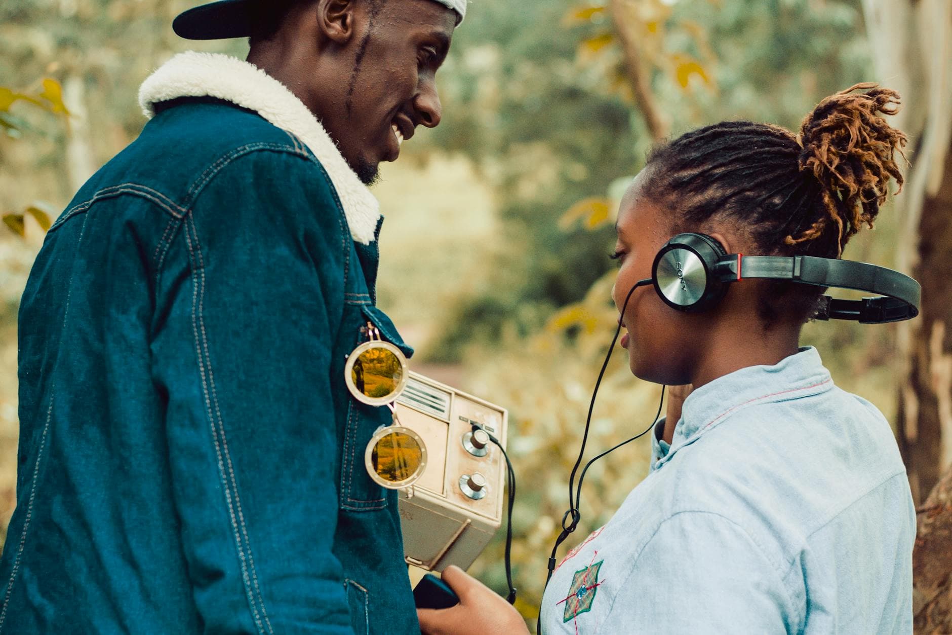 Two people enjoying a vintage radio experience outdoors in Kiambu, Kenya. - active listening partner