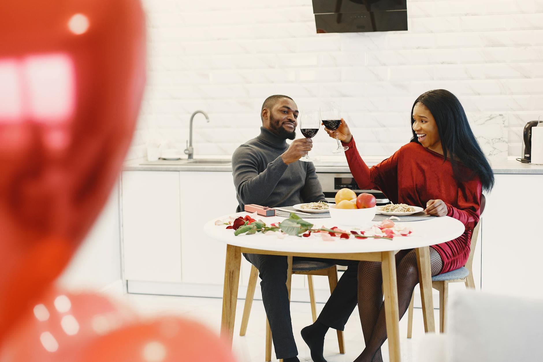 Couple enjoying a romantic indoor dinner with wine and roses. - couple resolutions