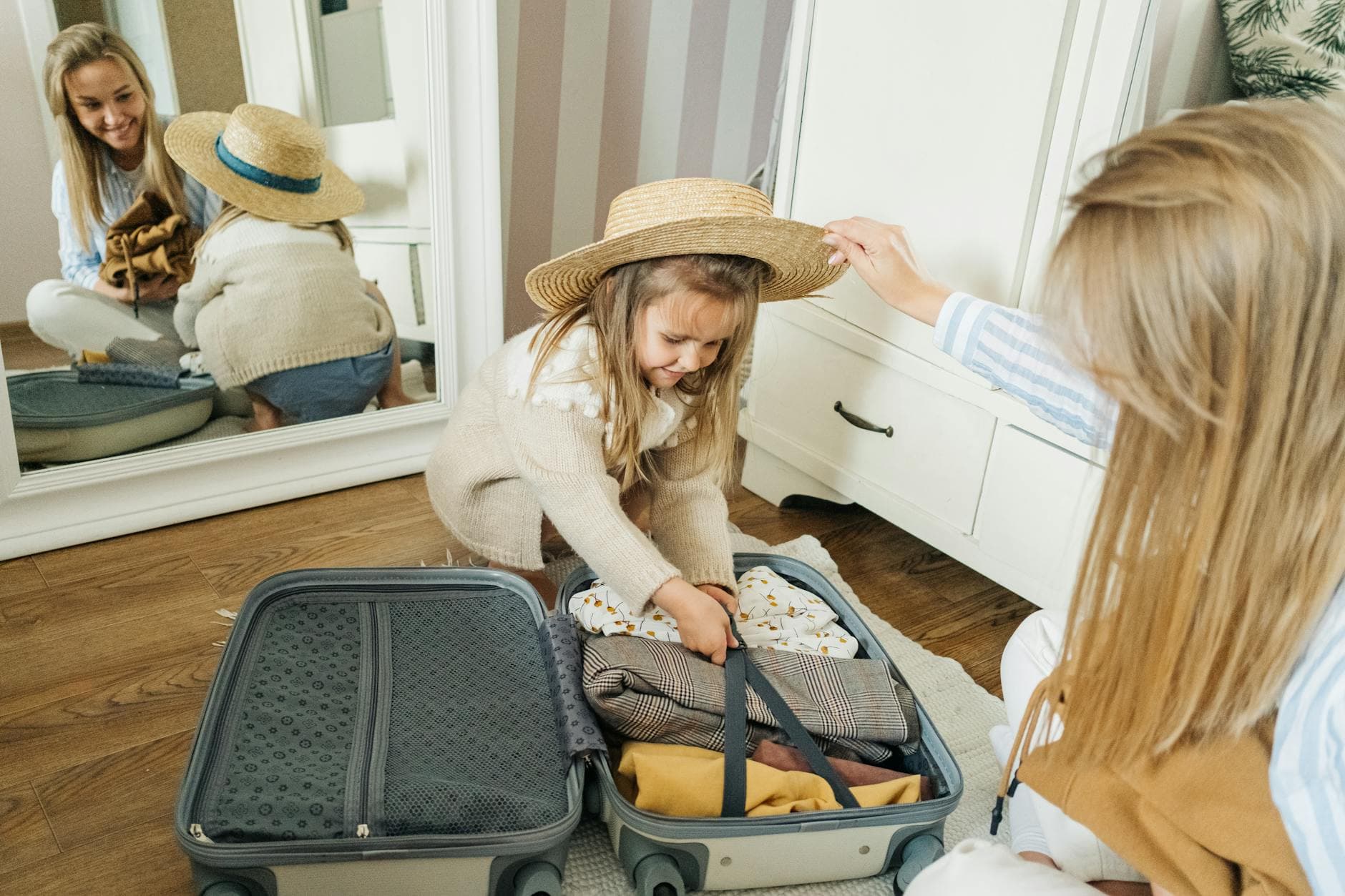 A mother and daughter pack a suitcase for a summer vacation, creating joyful memories. - letting go of baggage