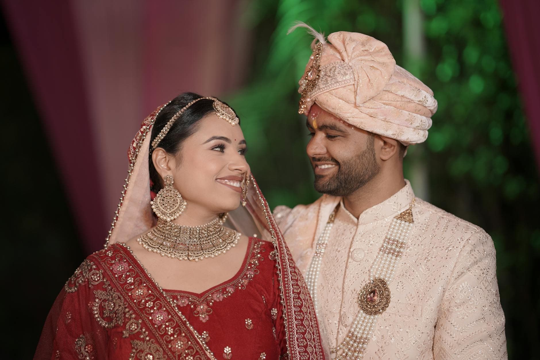 A joyful Indian couple in traditional wedding attire, adorned with intricate embroidery and jewelry. - marriage joy rediscovery
