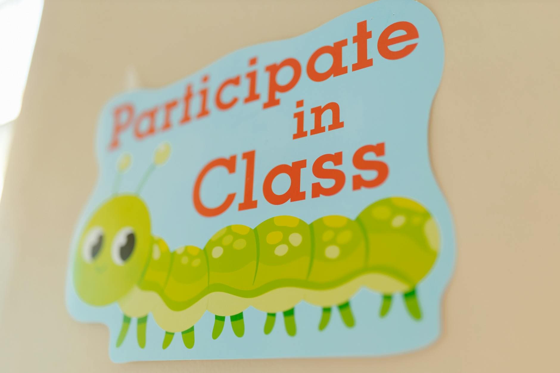 A brightly colored sign encouraging class participation featuring a cute caterpillar design. - preschool spring schedule
