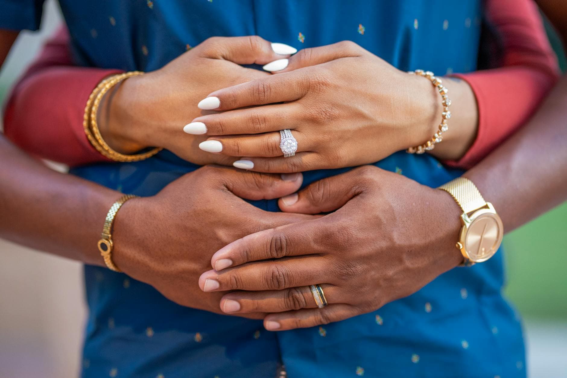Intimate close-up shot of a couple's hands, showcasing elegant jewelry and engagement rings. - rebuild marriage intimacy