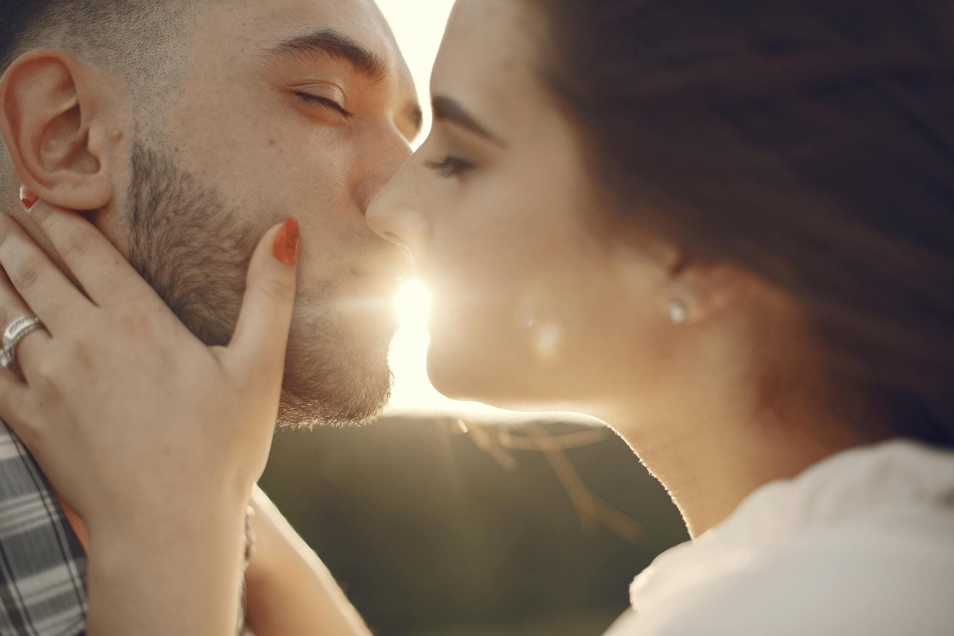 A loving couple shares a tender kiss in the warm glow of sunset. - rekindle relationship passion