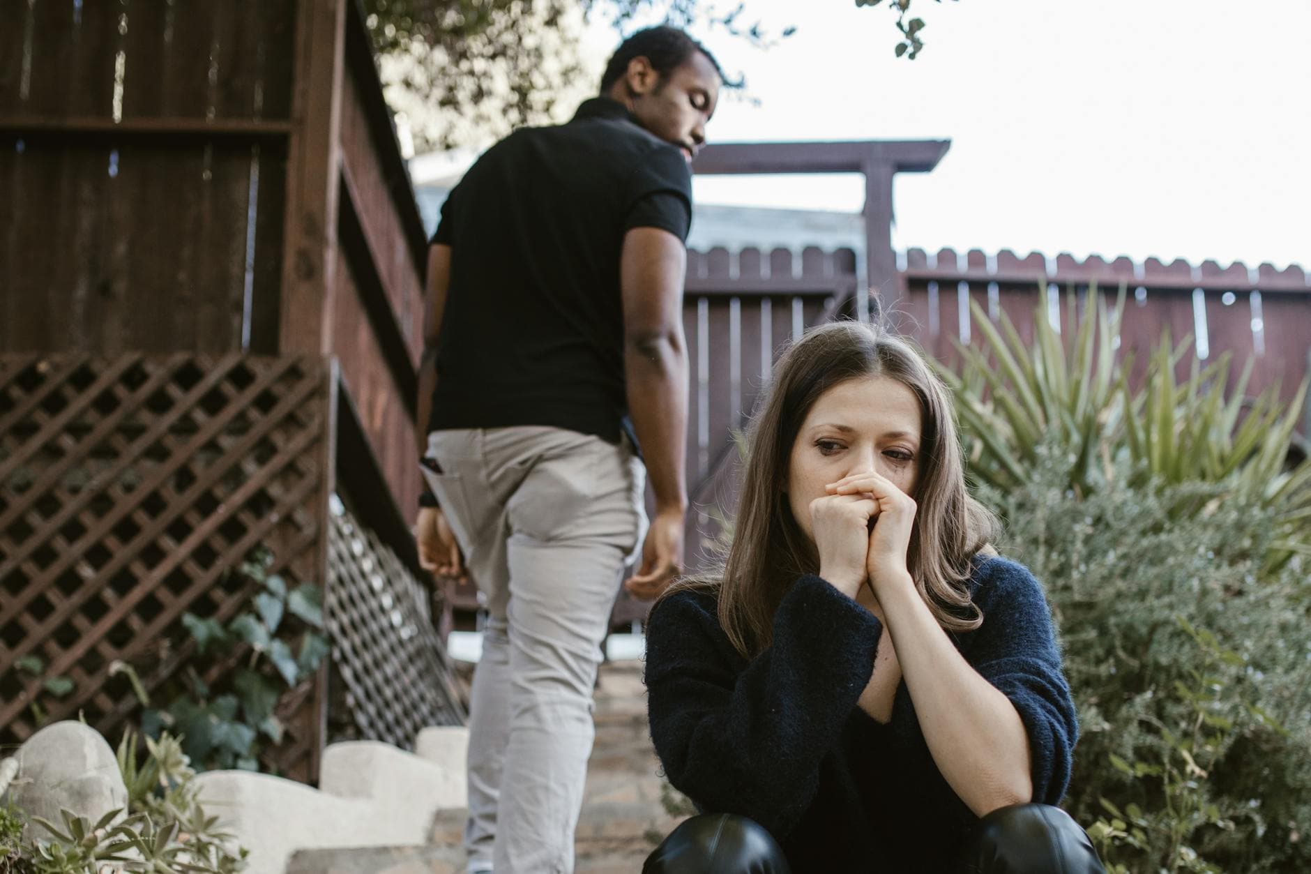 A couple facing emotional struggles captured in an outdoor setting. - relationship conflict spring