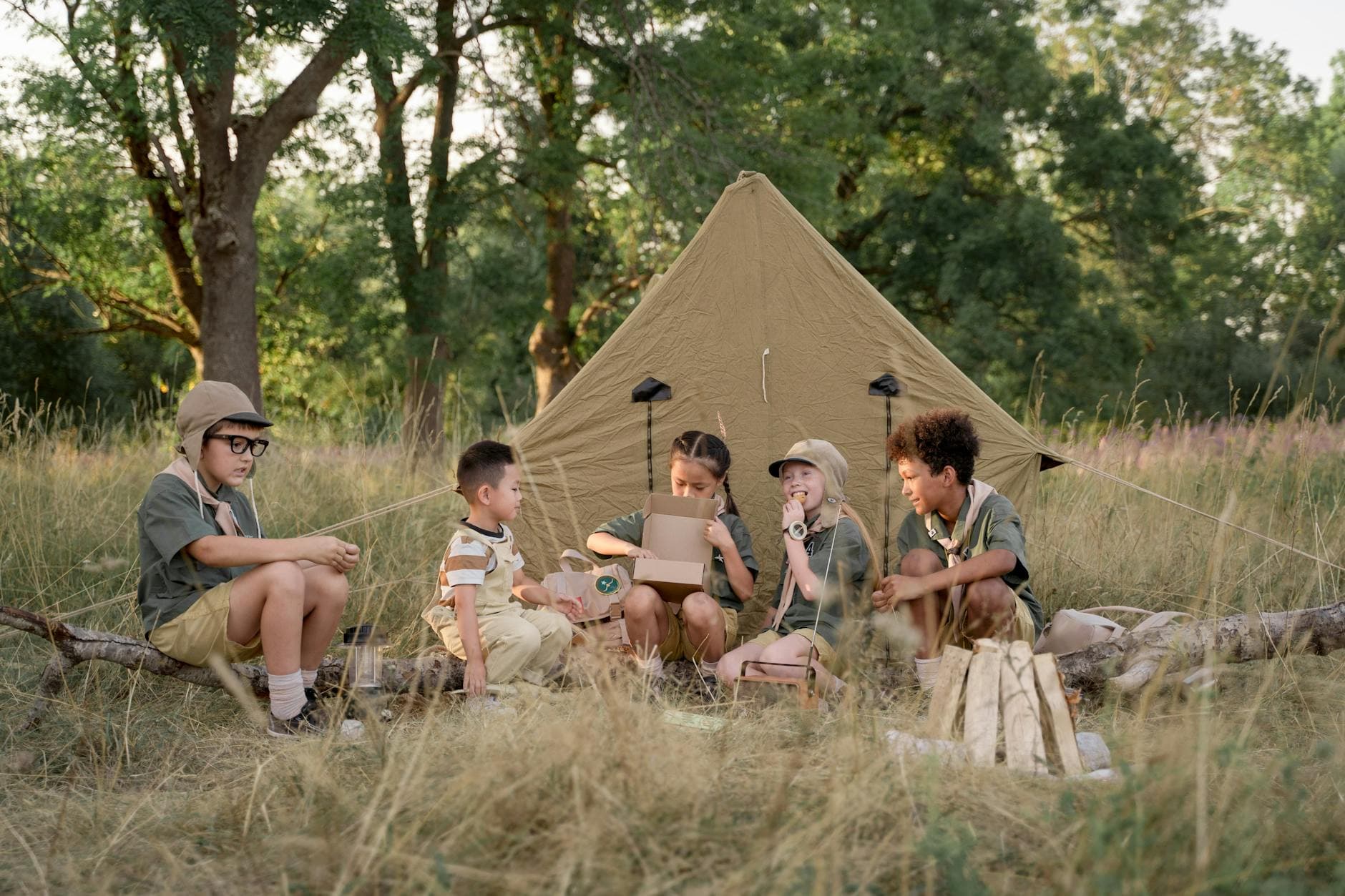 A group of children camping in the wilderness, enjoying outdoor activities and nature exploration. - summer camp fears