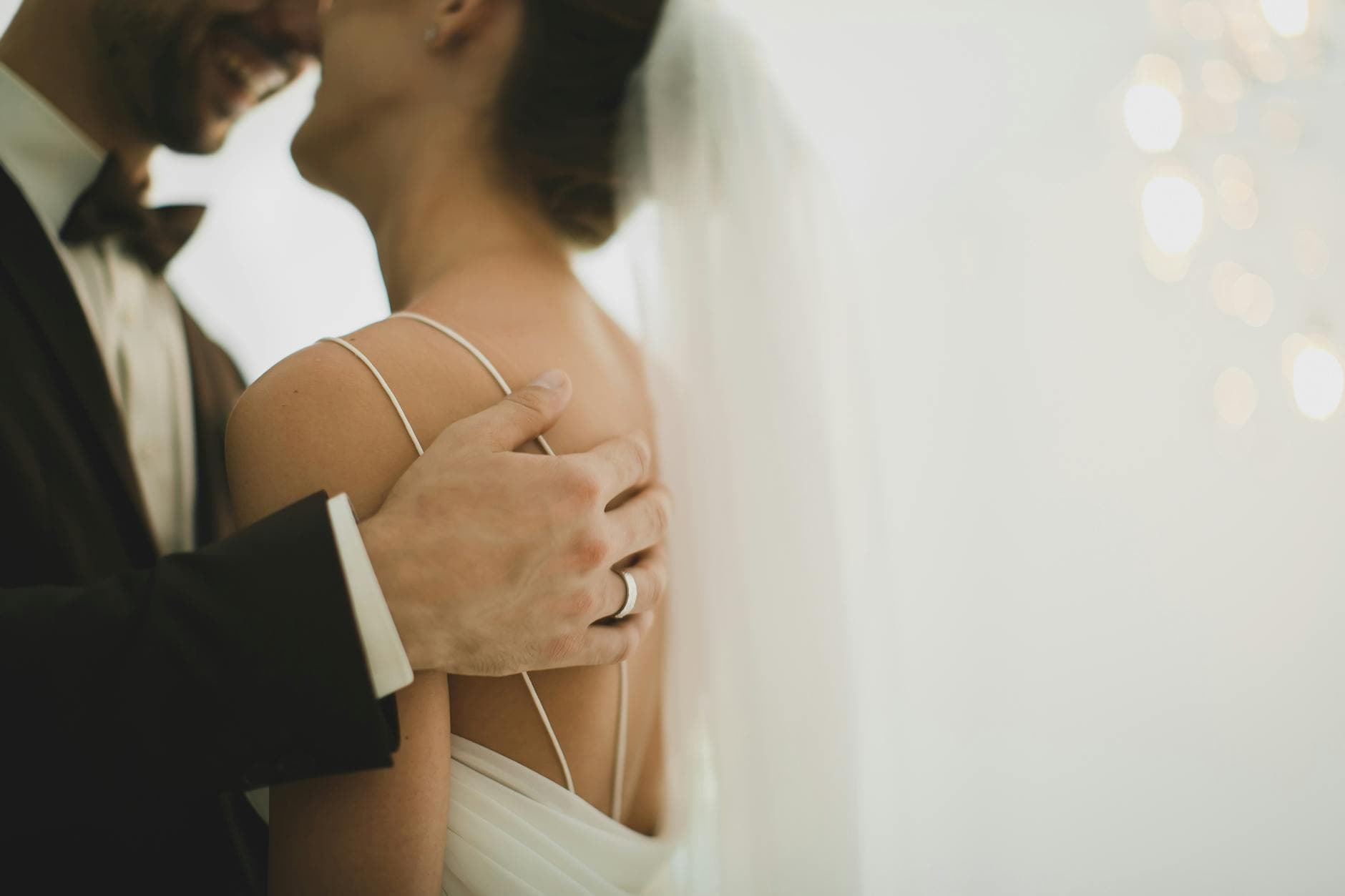 Intimate close-up of a newlywed couple embracing, showcasing love and togetherness. - wedding stress relief