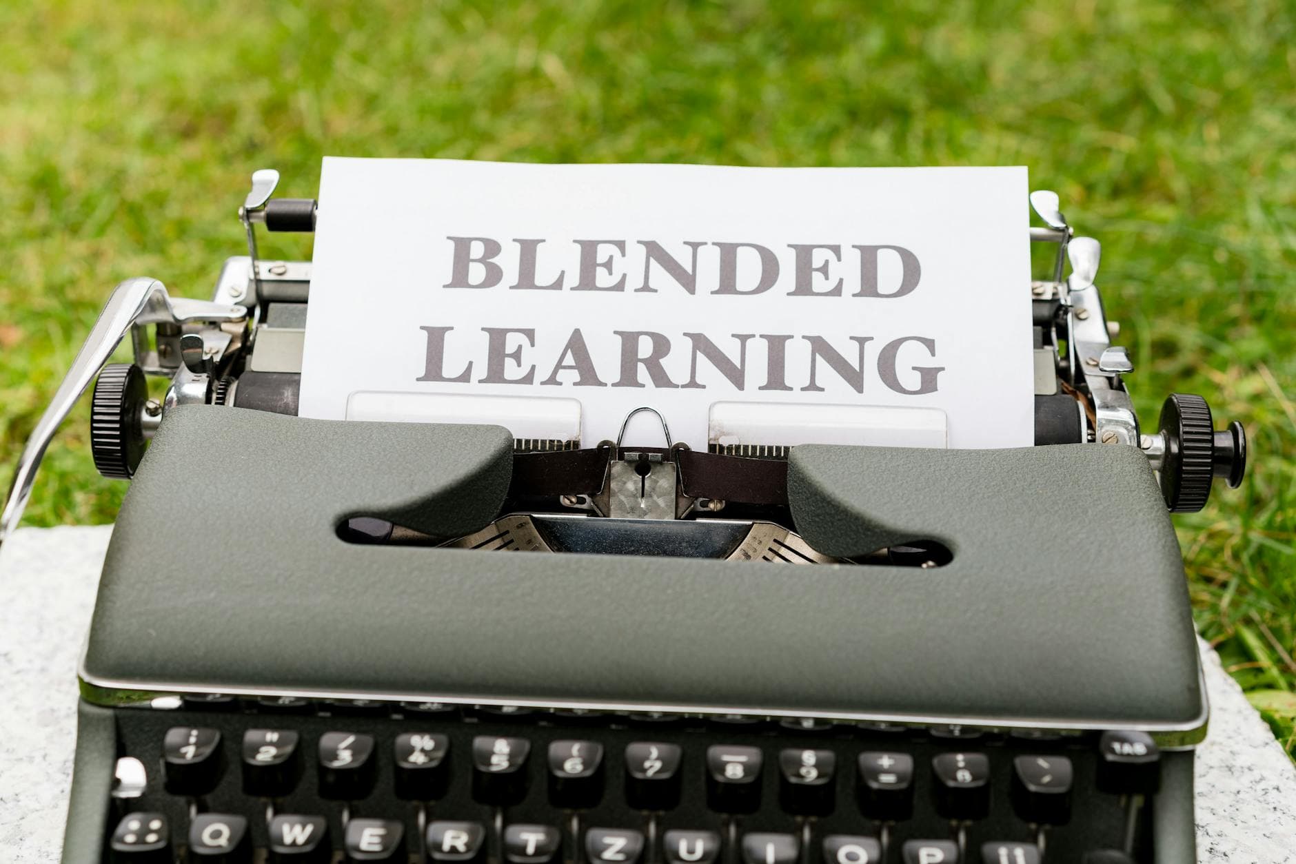 Vintage typewriter with a paper showing 'Blended Learning' text on grass. - blended family communication strategies