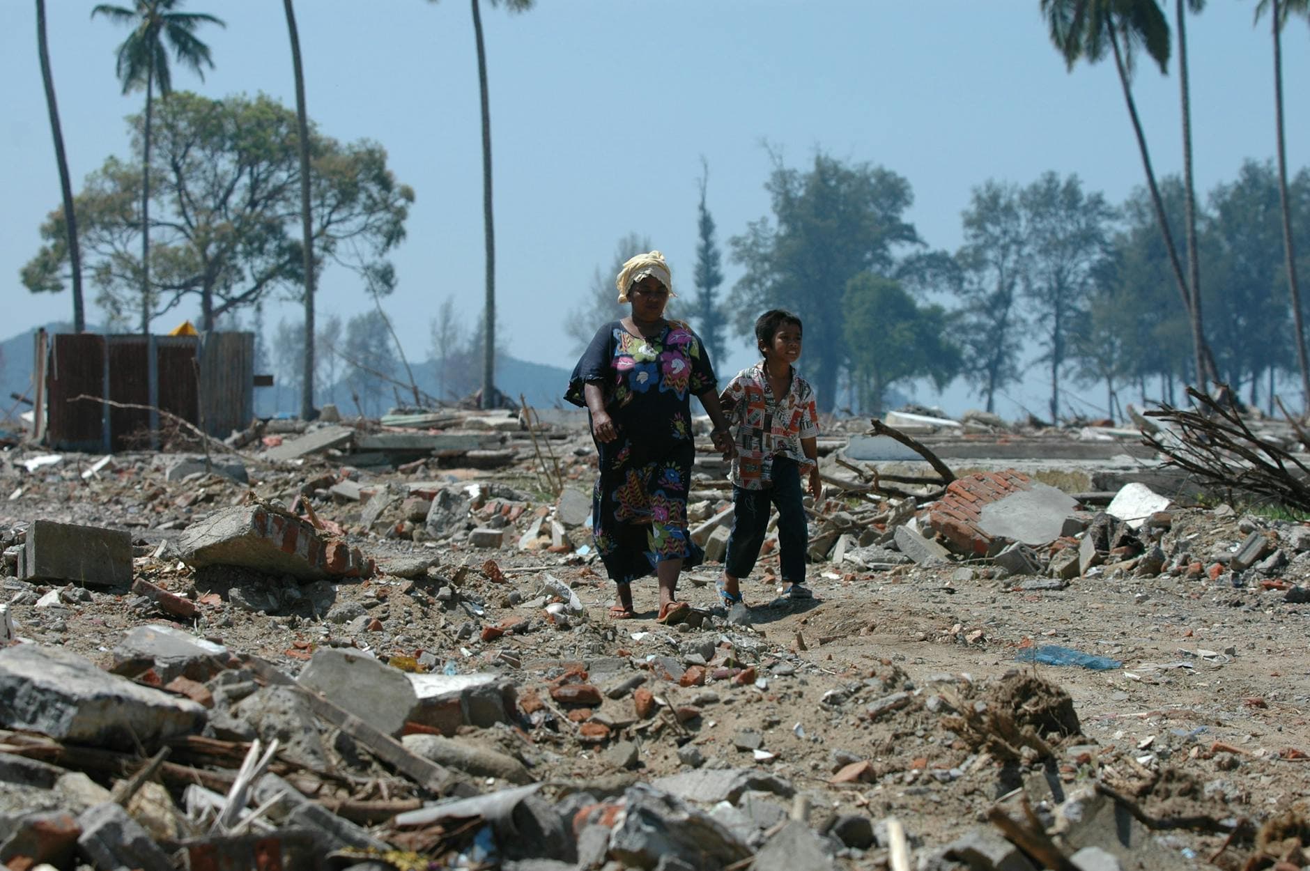 Two people walk through debris in Banda Aceh, Indonesia after a devastating tsunami. - rebuilding trust in marriage