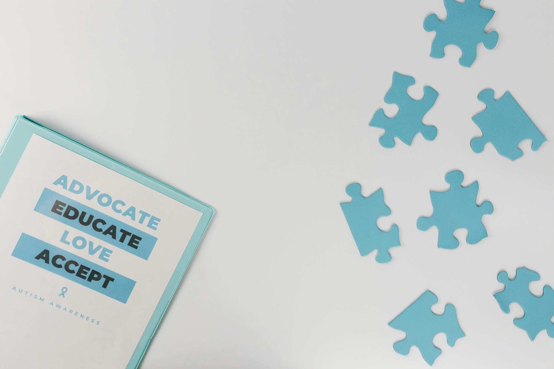 Blue puzzle pieces with advocacy messages for autism awareness. - acceptance and commitment therapy spring