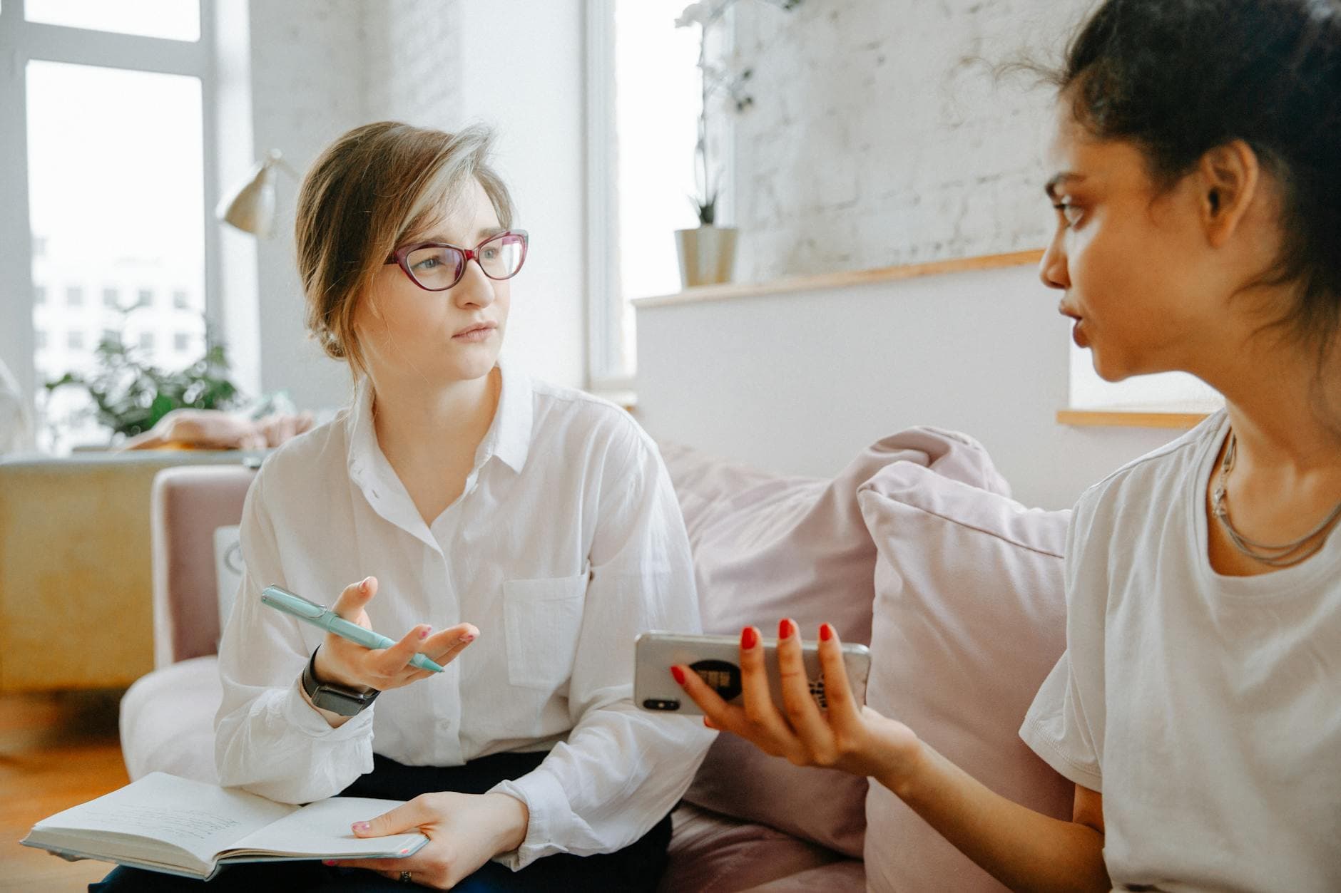 Therapist and client discussing mental health issues during a counseling session in a bright, cozy room. - assertive communication skills