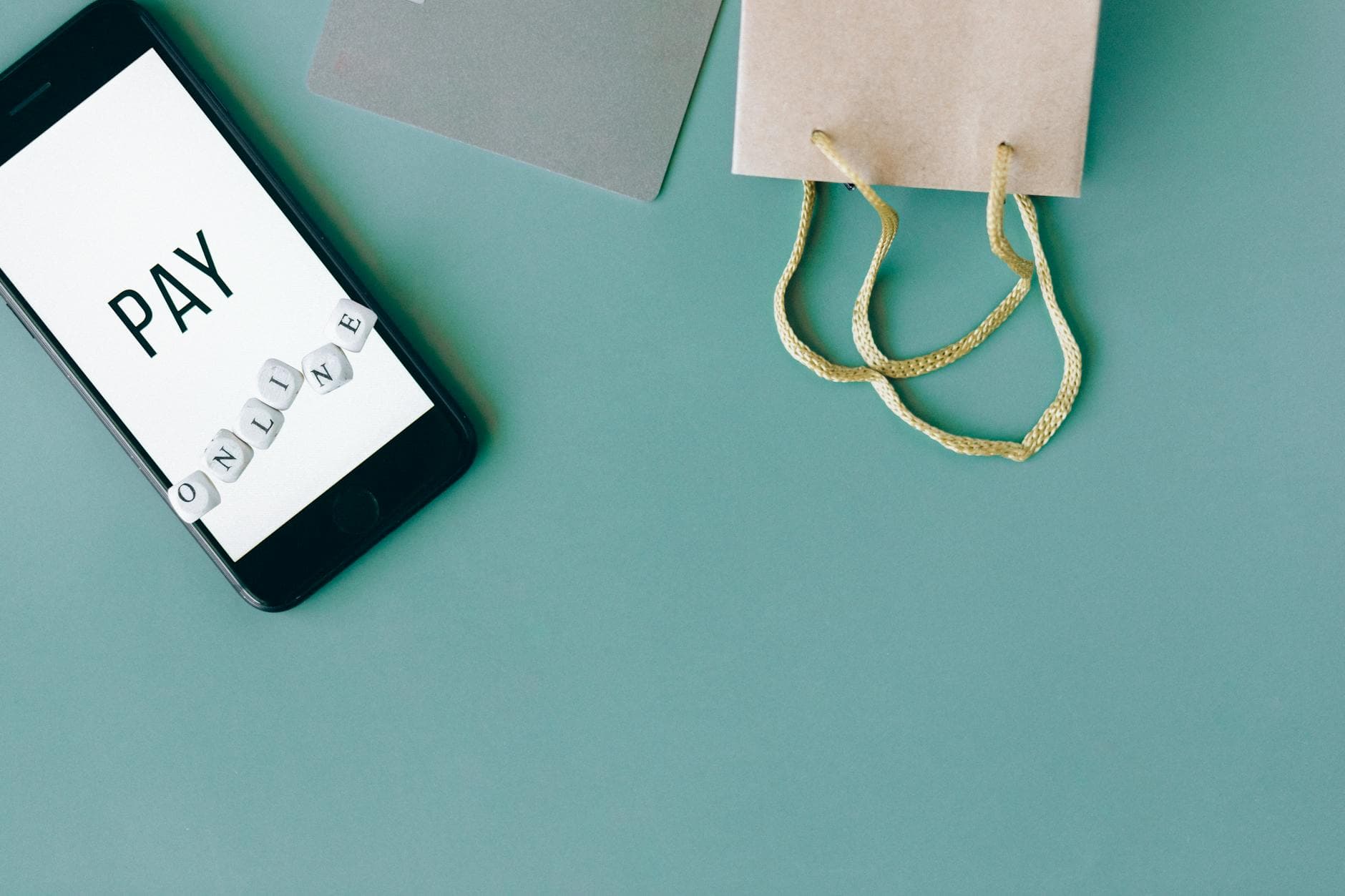 Illustration of online payment with smartphone, credit card, and shopping bag on mint background. - first message online dating