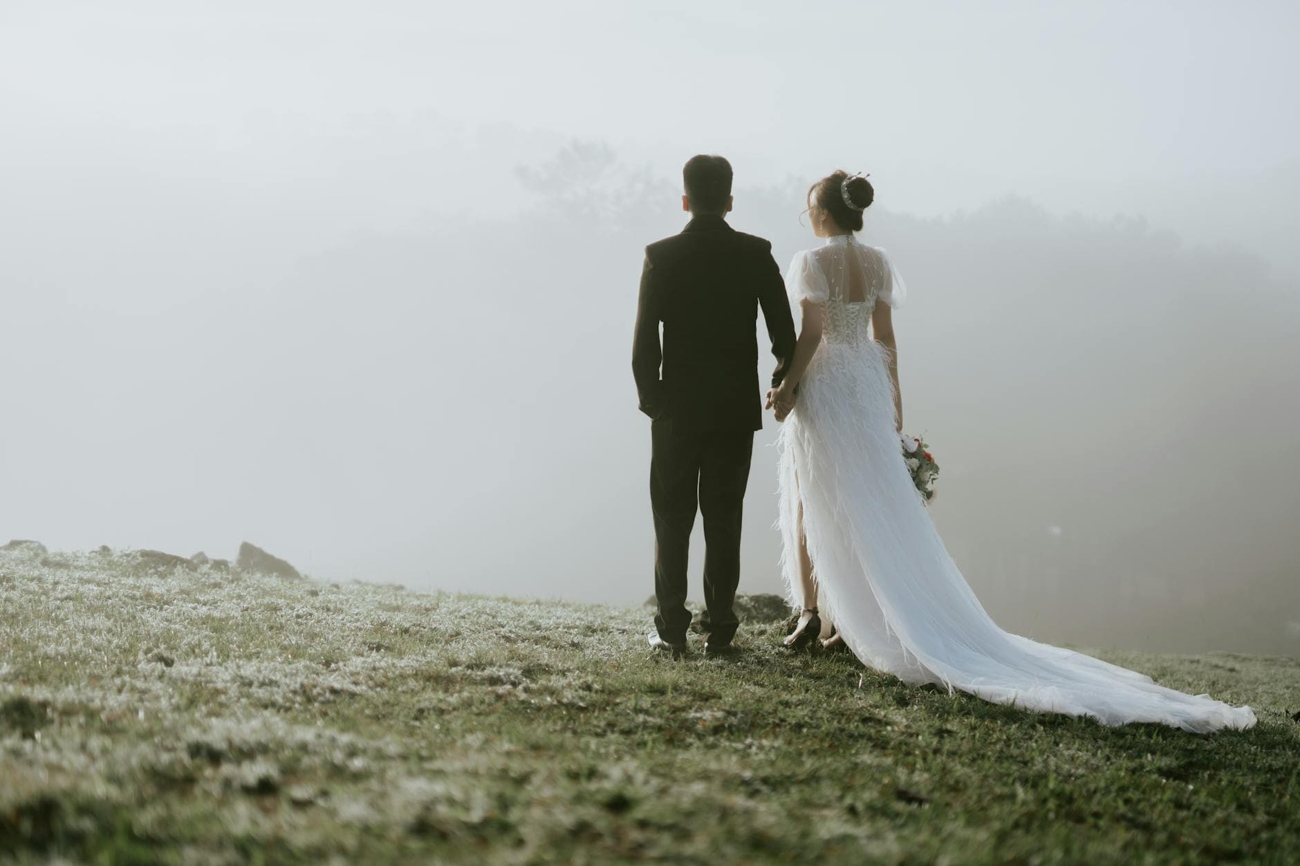 Elegant bride and groom holding hands in a misty rural landscape, celebrating love. - gratitude in marriage