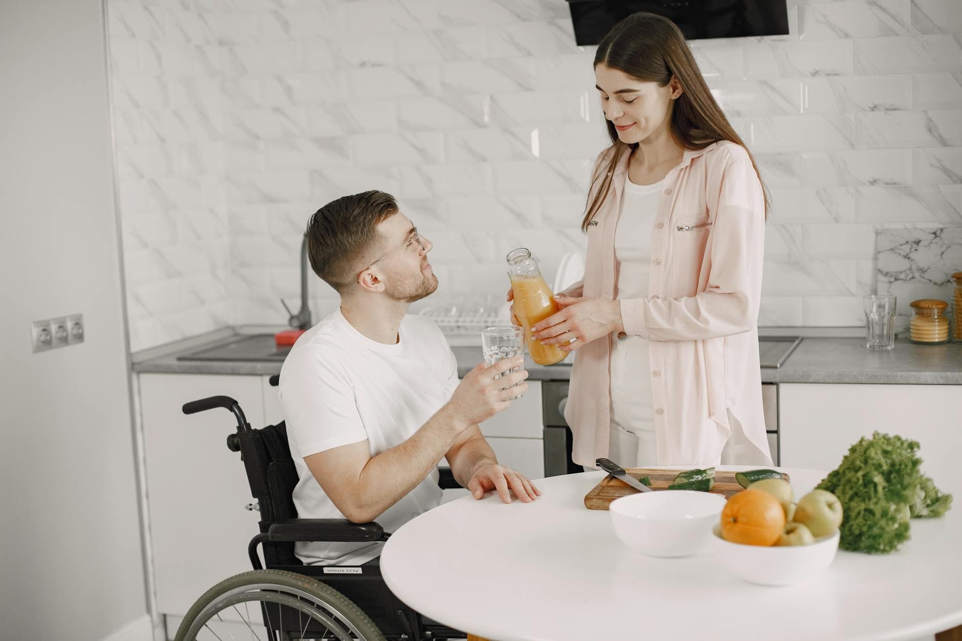 Couple enjoying time together in a kitchen, sharing a drink. Love and care in action. - healthy relationship communication
