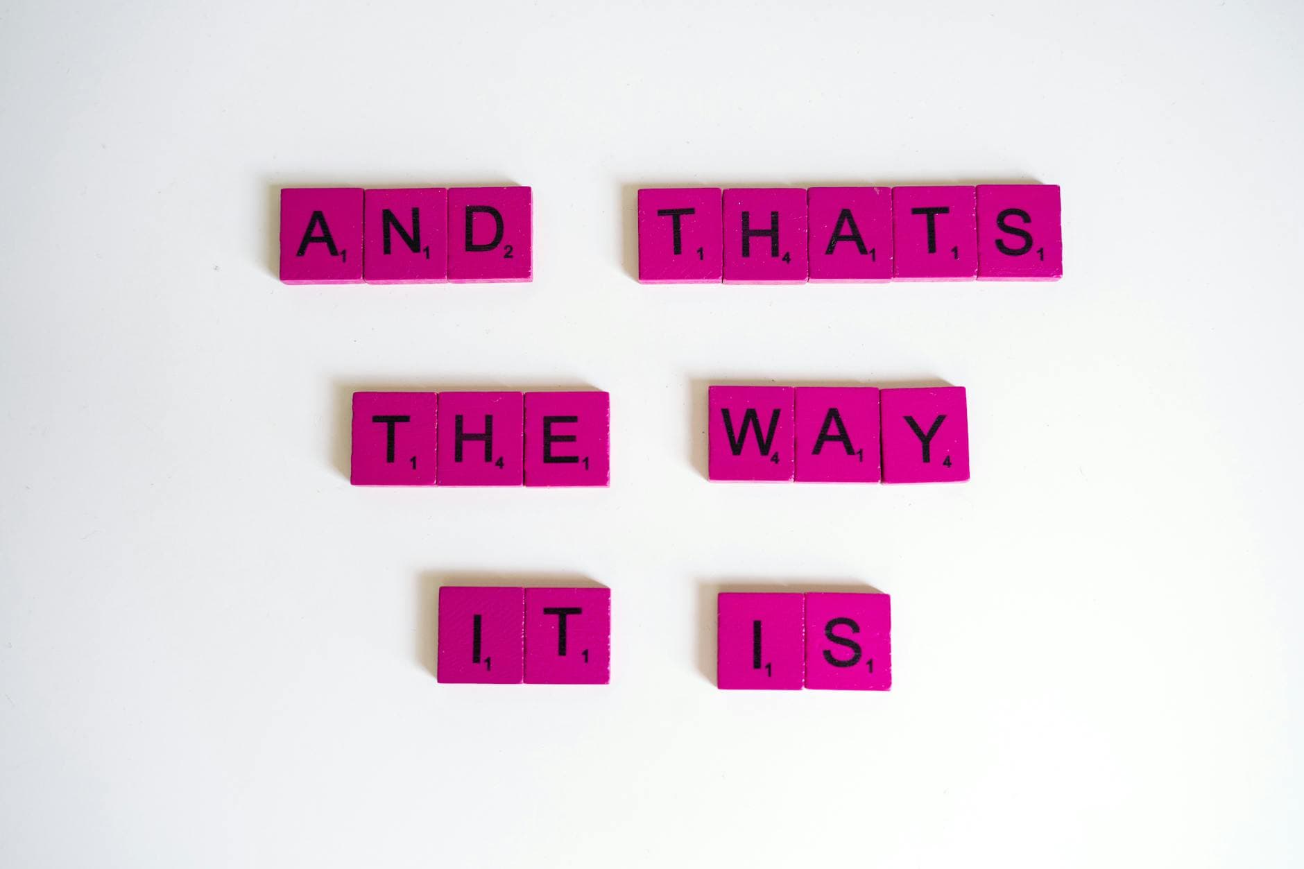 Inspirational quote 'And That's The Way It Is' on pink Scrabble tiles. - i feel statements