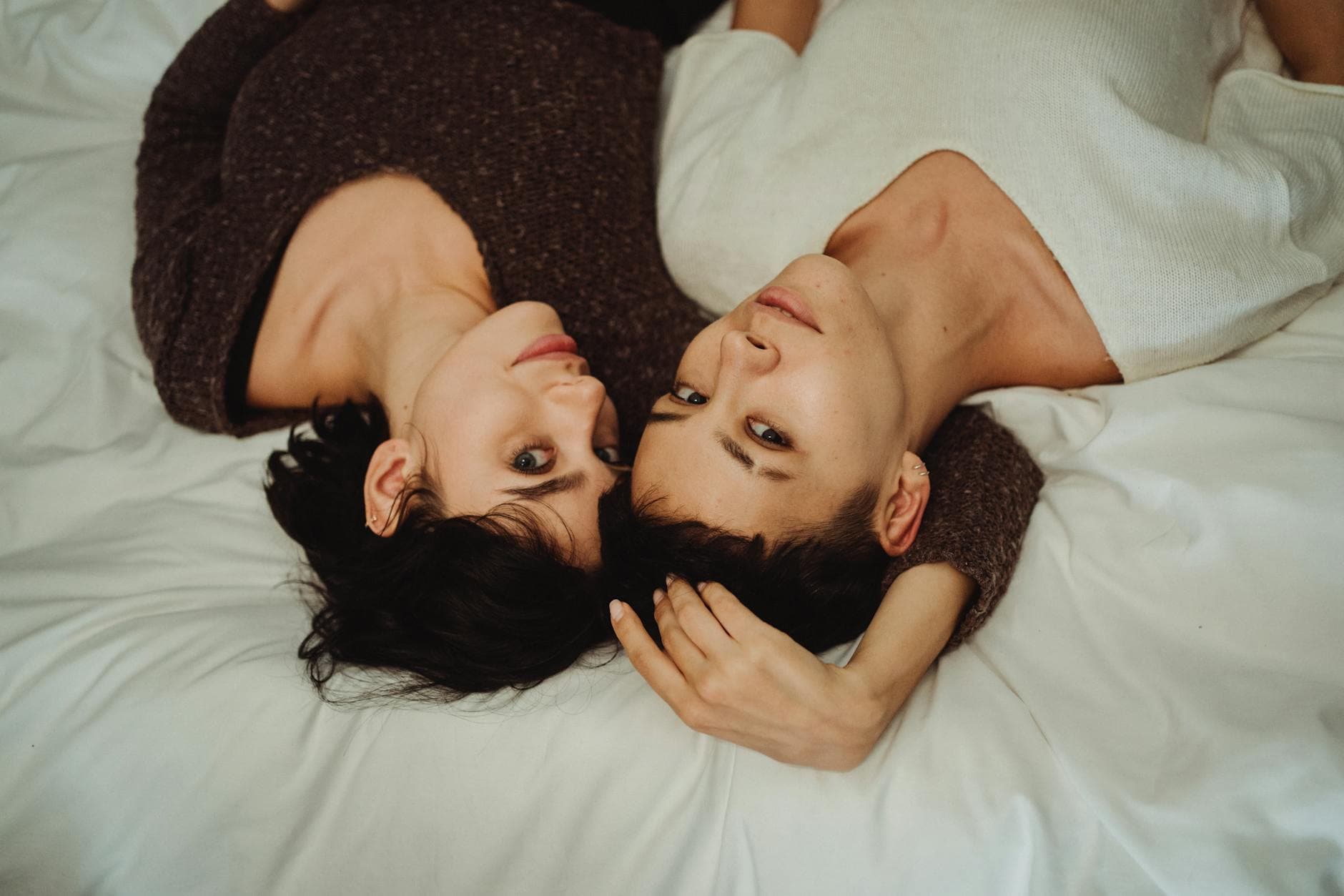 A loving couple lying together on a bed, embracing and showing affection. - how to show platonic love