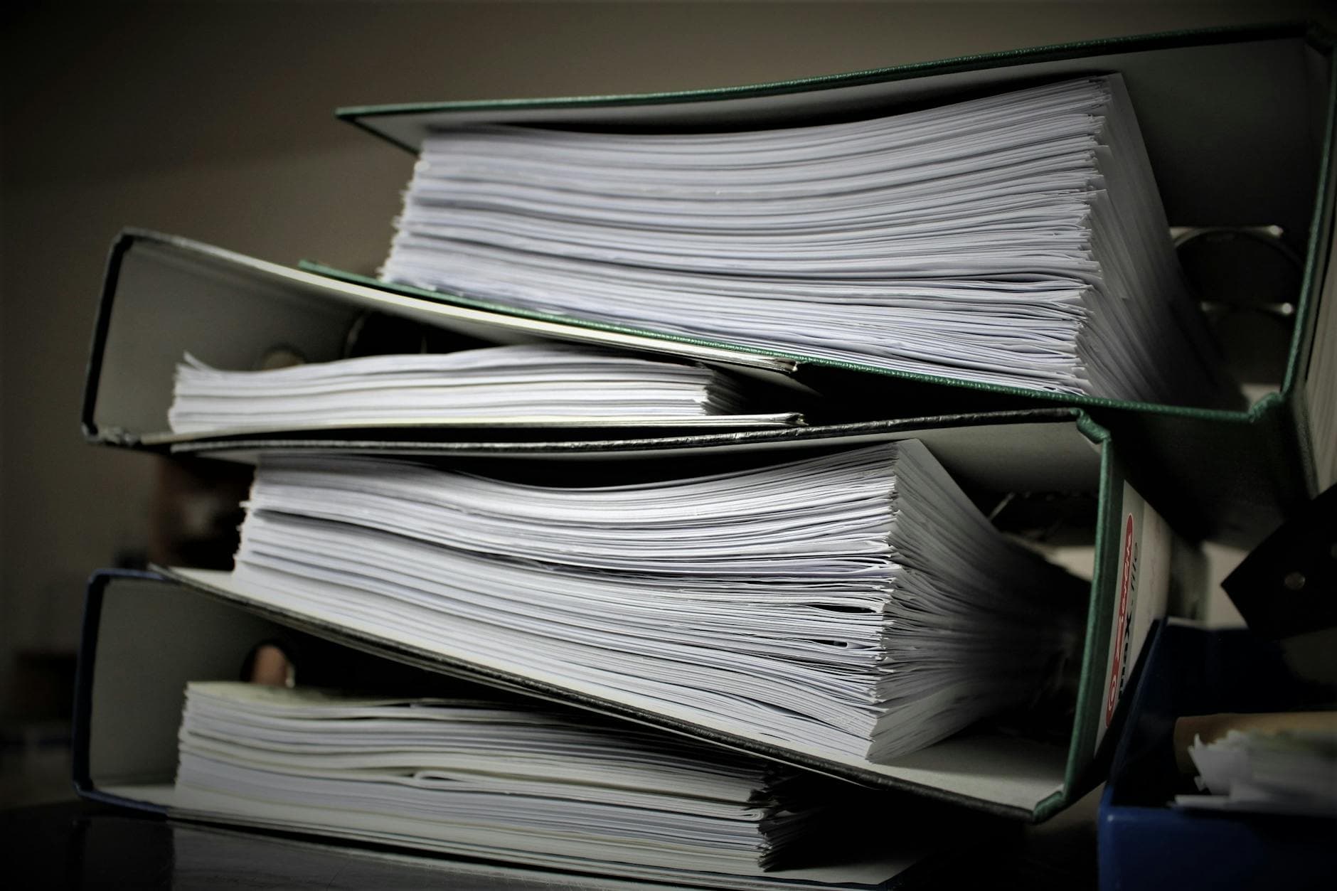 Close-up of stacked binders filled with documents for office or educational use. - workplace dating policy