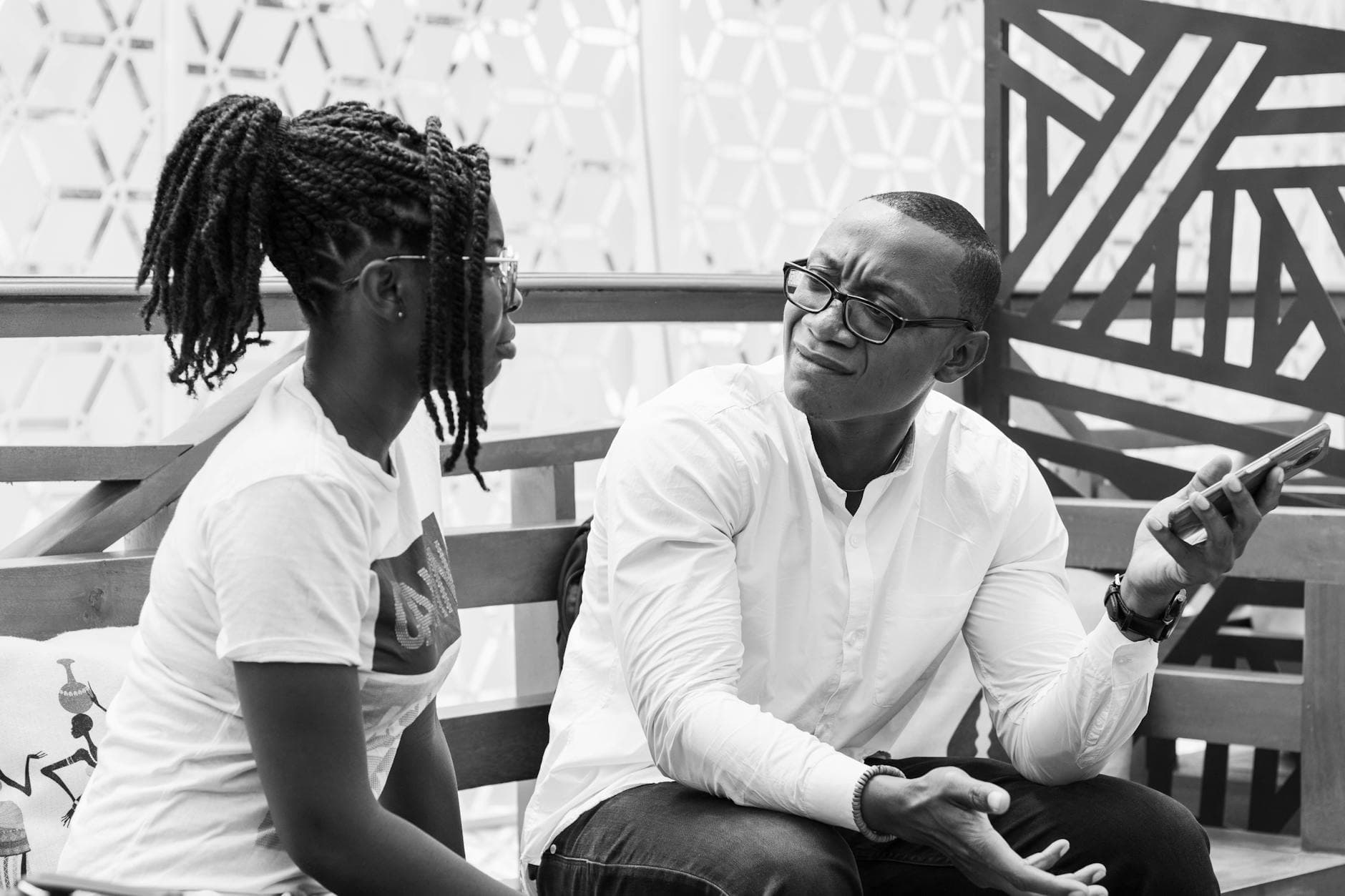 Black and white photo of a couple having a conversation outdoors in Accra, Ghana. - active listening couples