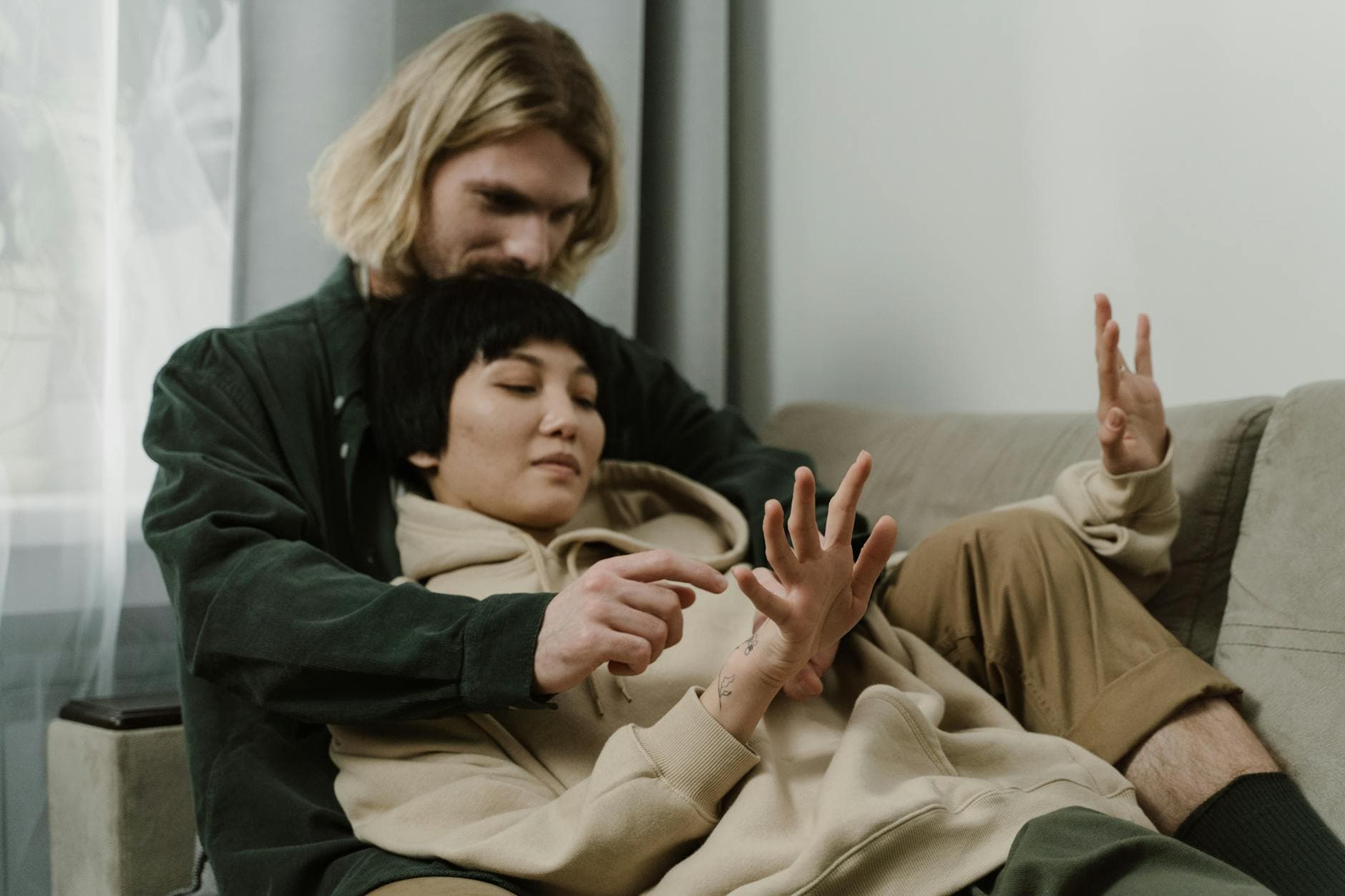 A couple enjoying a quiet and intimate moment on a cozy sofa indoors. - attachment styles explained