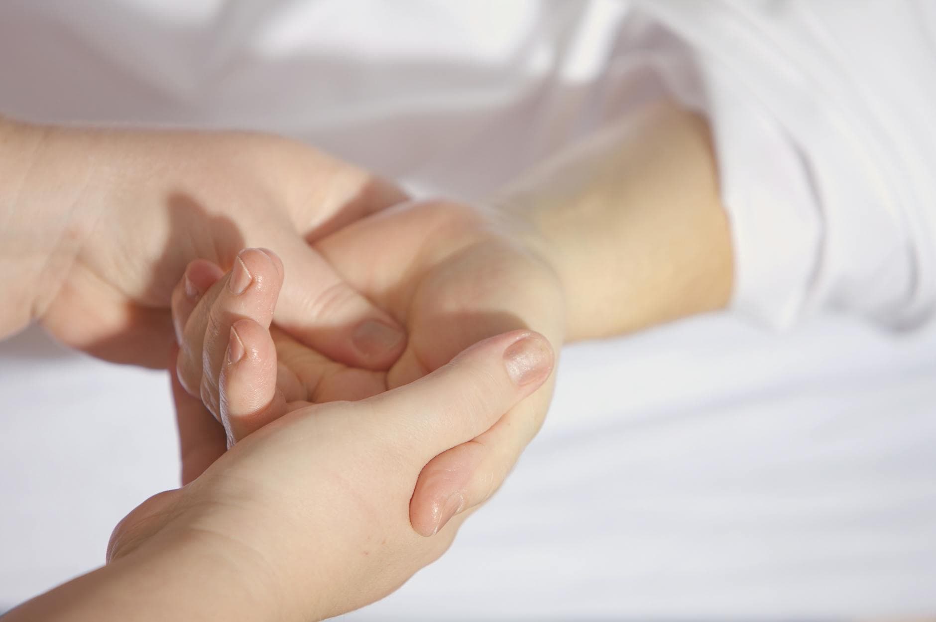Relaxing hand massage therapy session close-up with gentle touch and care. - somatic healing