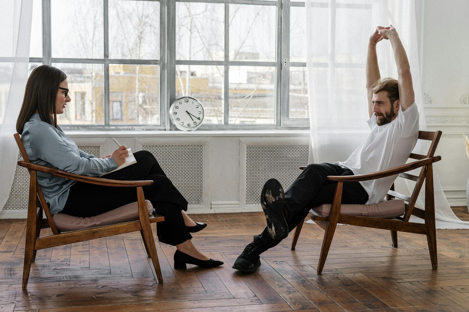 A counselor and client engaged in a therapy session indoors, reflecting on emotions and solutions. - therapy stuck breakthrough