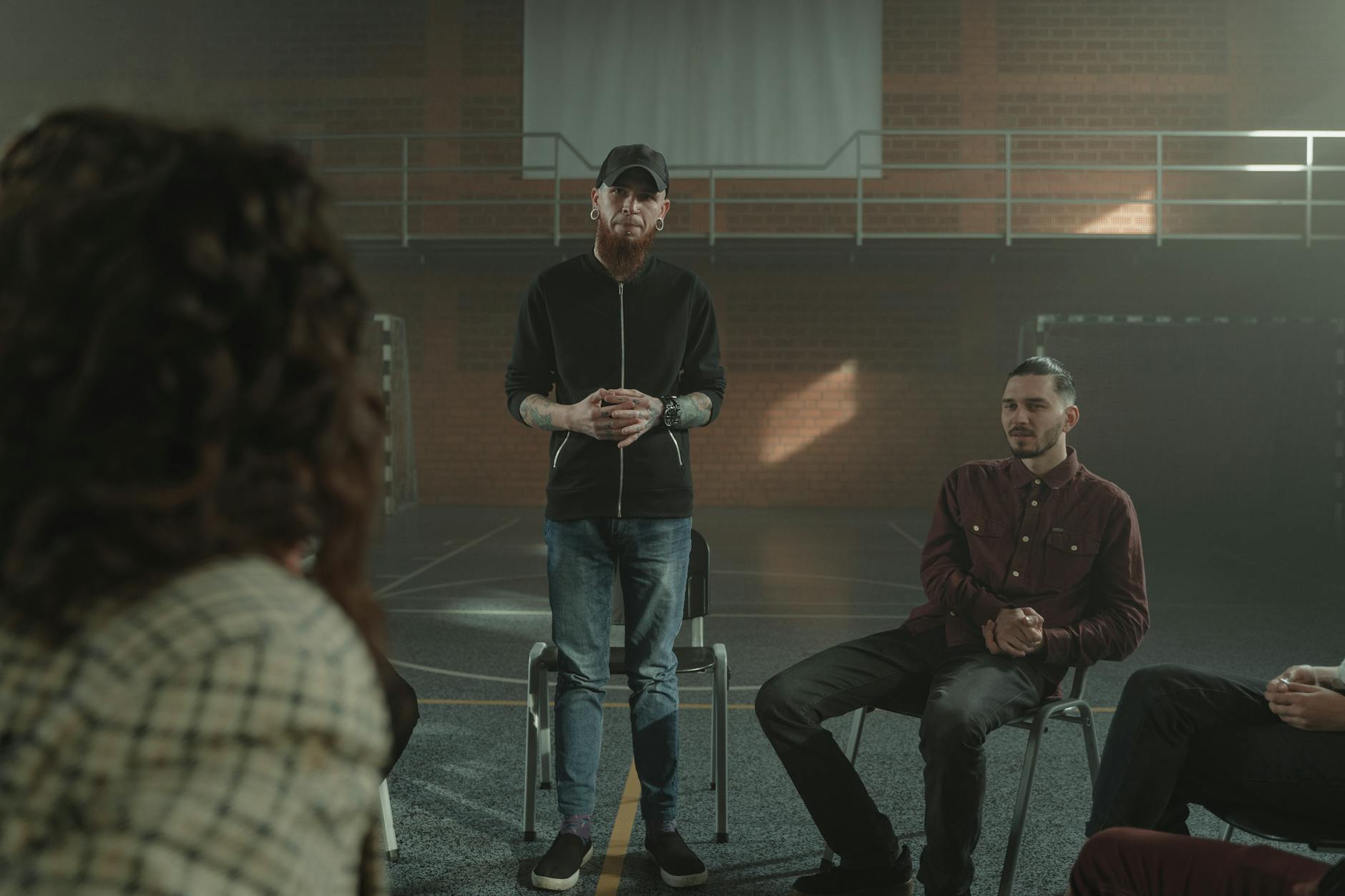 A group therapy session taking place indoors with diverse participants seated in a circle. - active listening in relationships