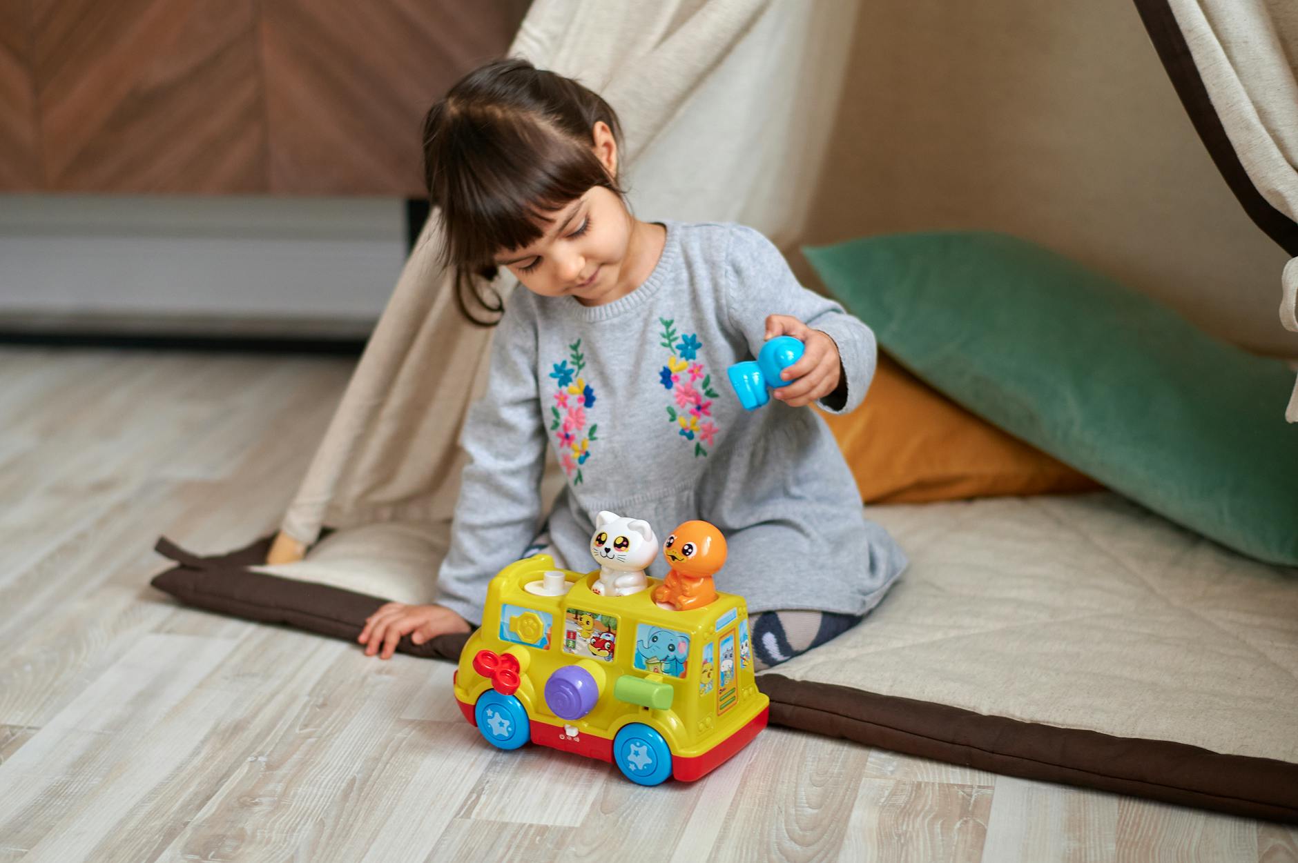 Adorable child playing with a toy car inside a cozy interior setting, showcasing innocence and playfulness. - child social emotional development break