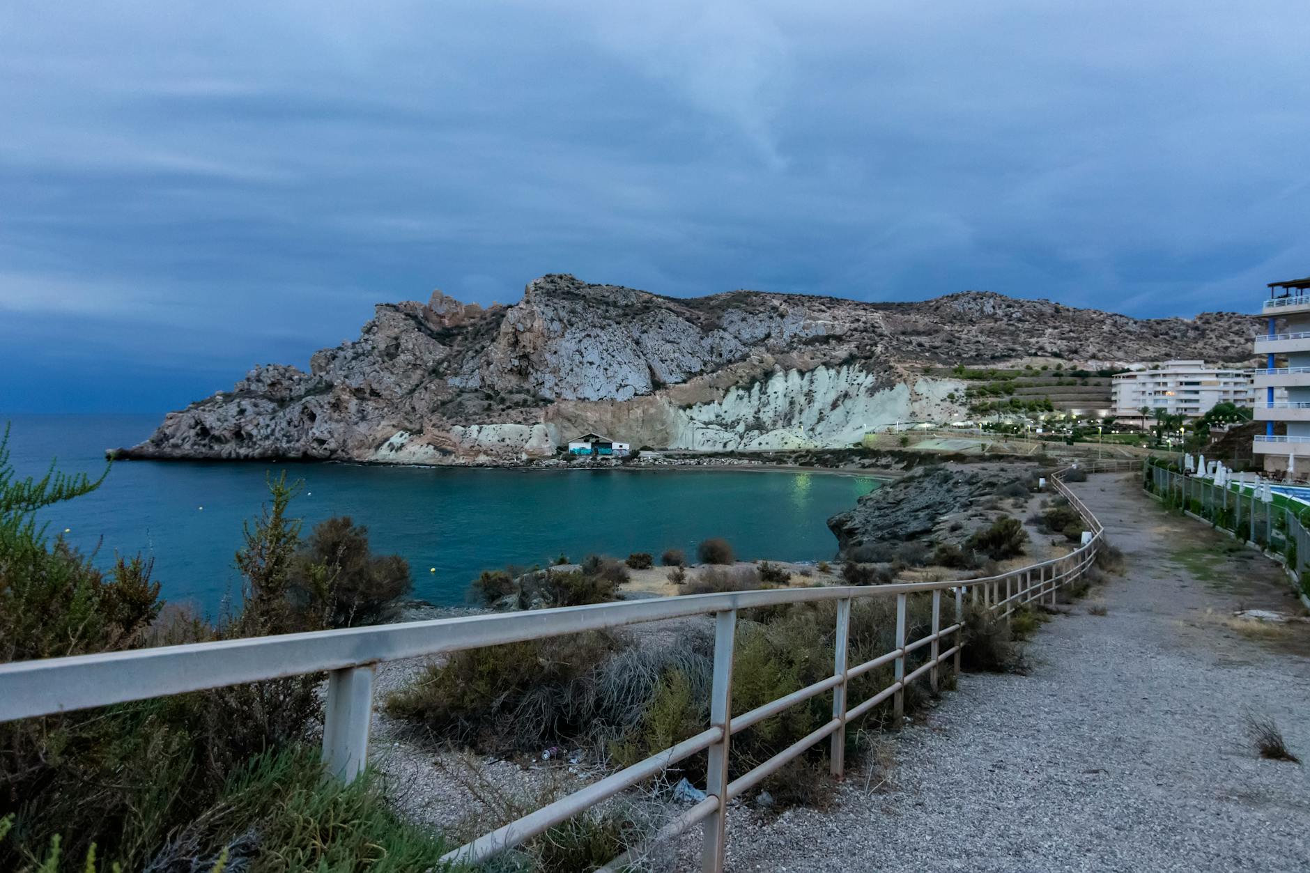 Scenic view of Águilas coast with path and railing leading to the rocky beach. - coping with winter blues