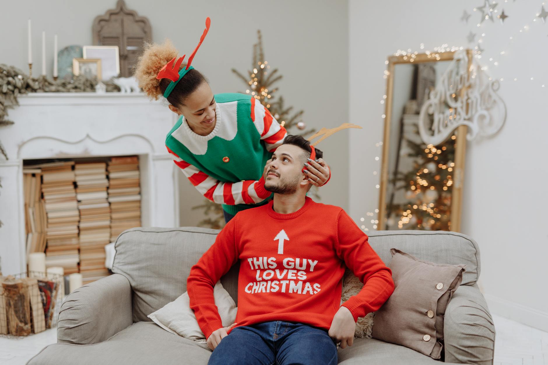 A joyful couple in colorful Christmas sweaters celebrating indoors, capturing holiday spirit. - couples therapy holiday season