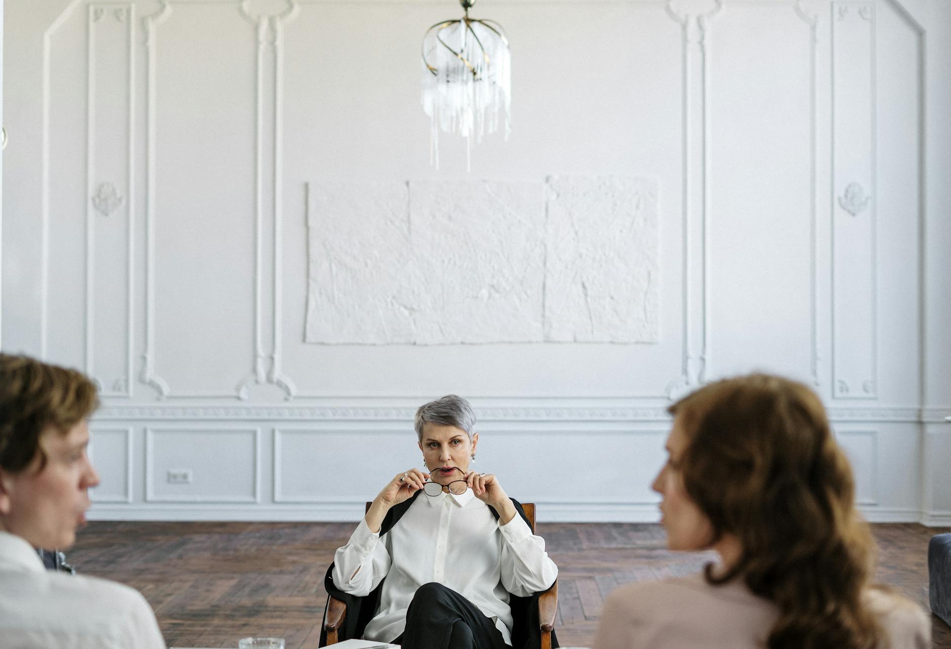A therapist guiding a couple through a counseling session in an elegant office setting. - couples therapy infidelity