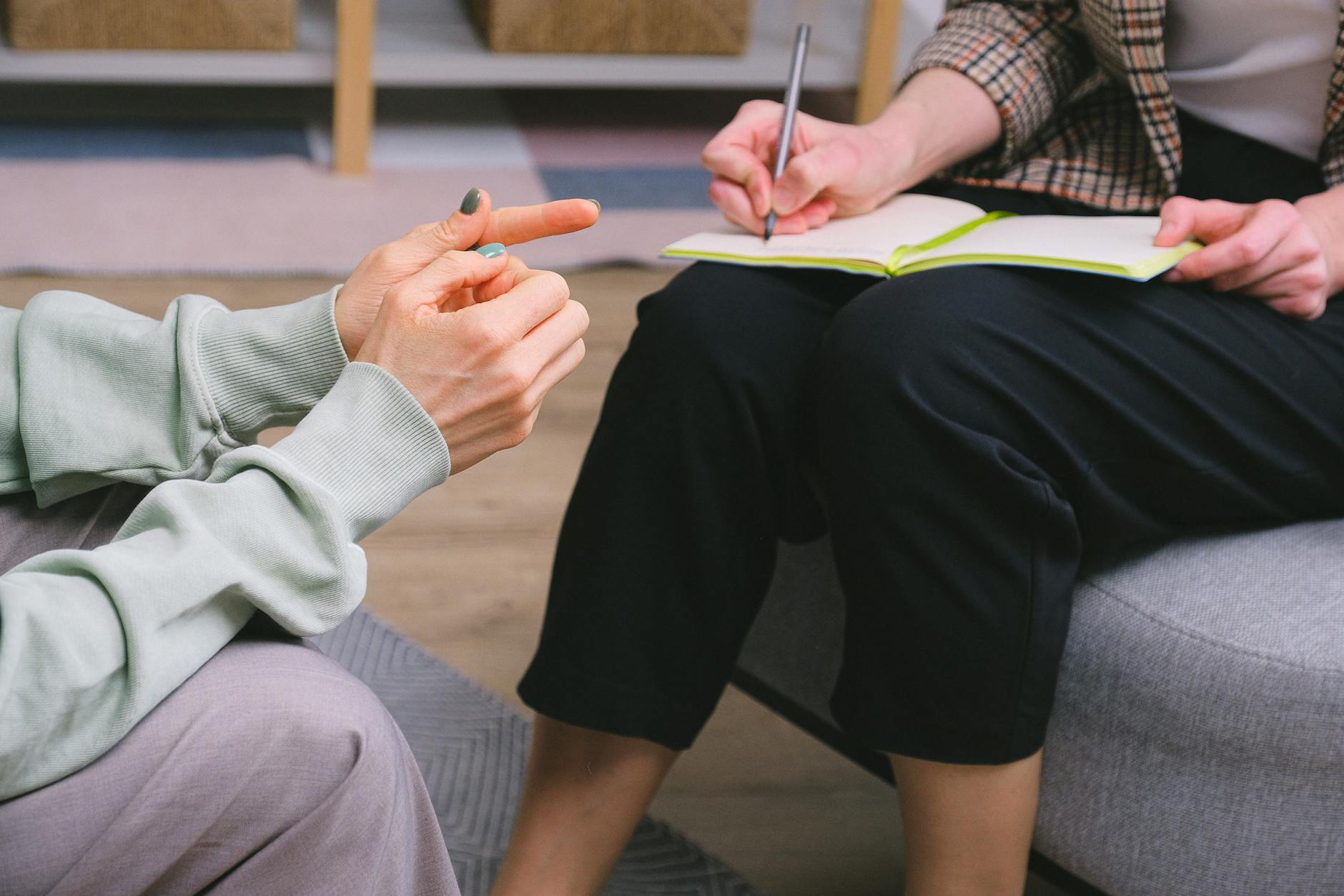 Close-up of a therapy session with a notebook and gestures indoors. - effective relationship communication skills