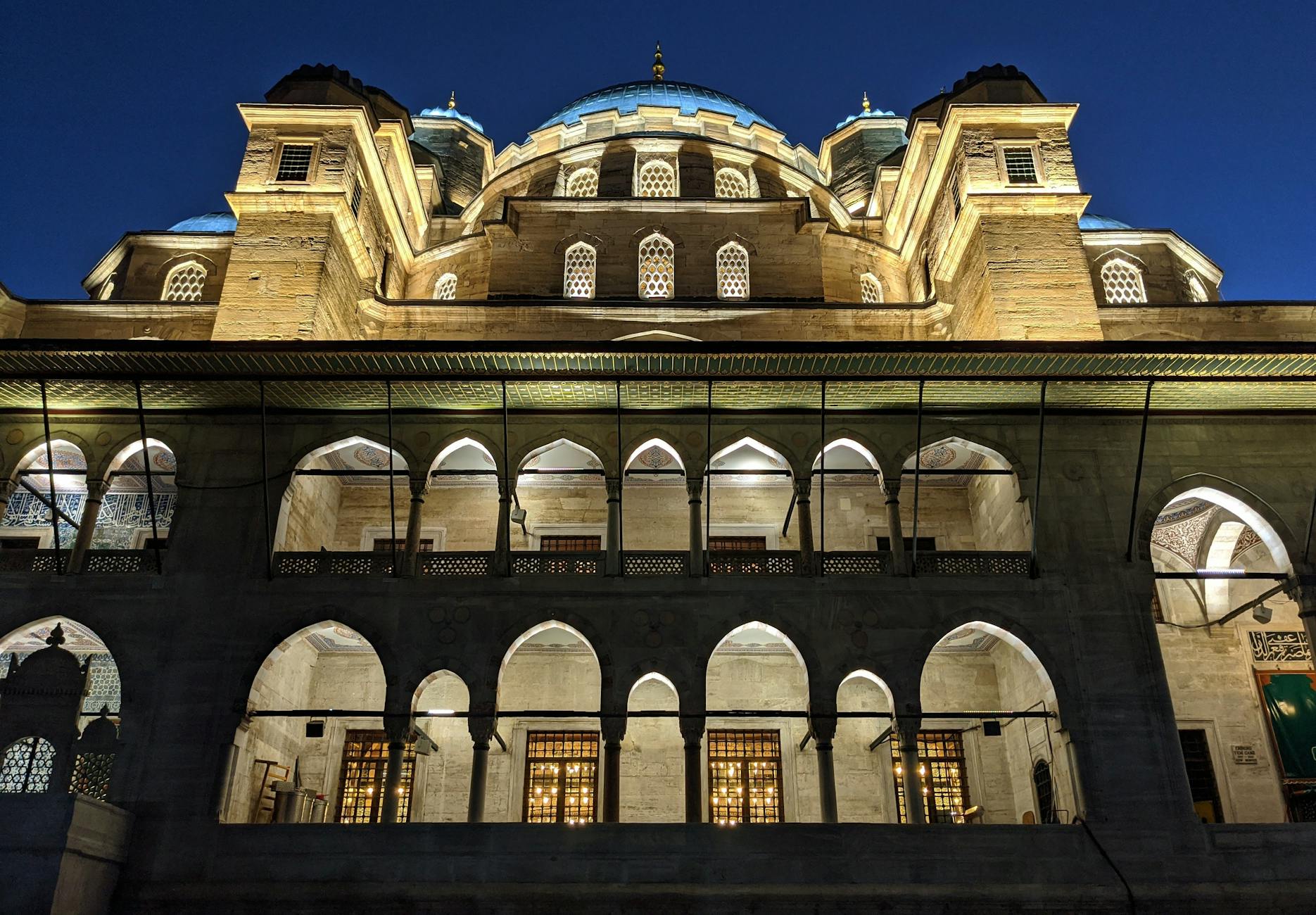 The Yeni Cami Mosque in Istanbul illuminated during the evening, showcasing its Ottoman architecture. - emotional validation definition