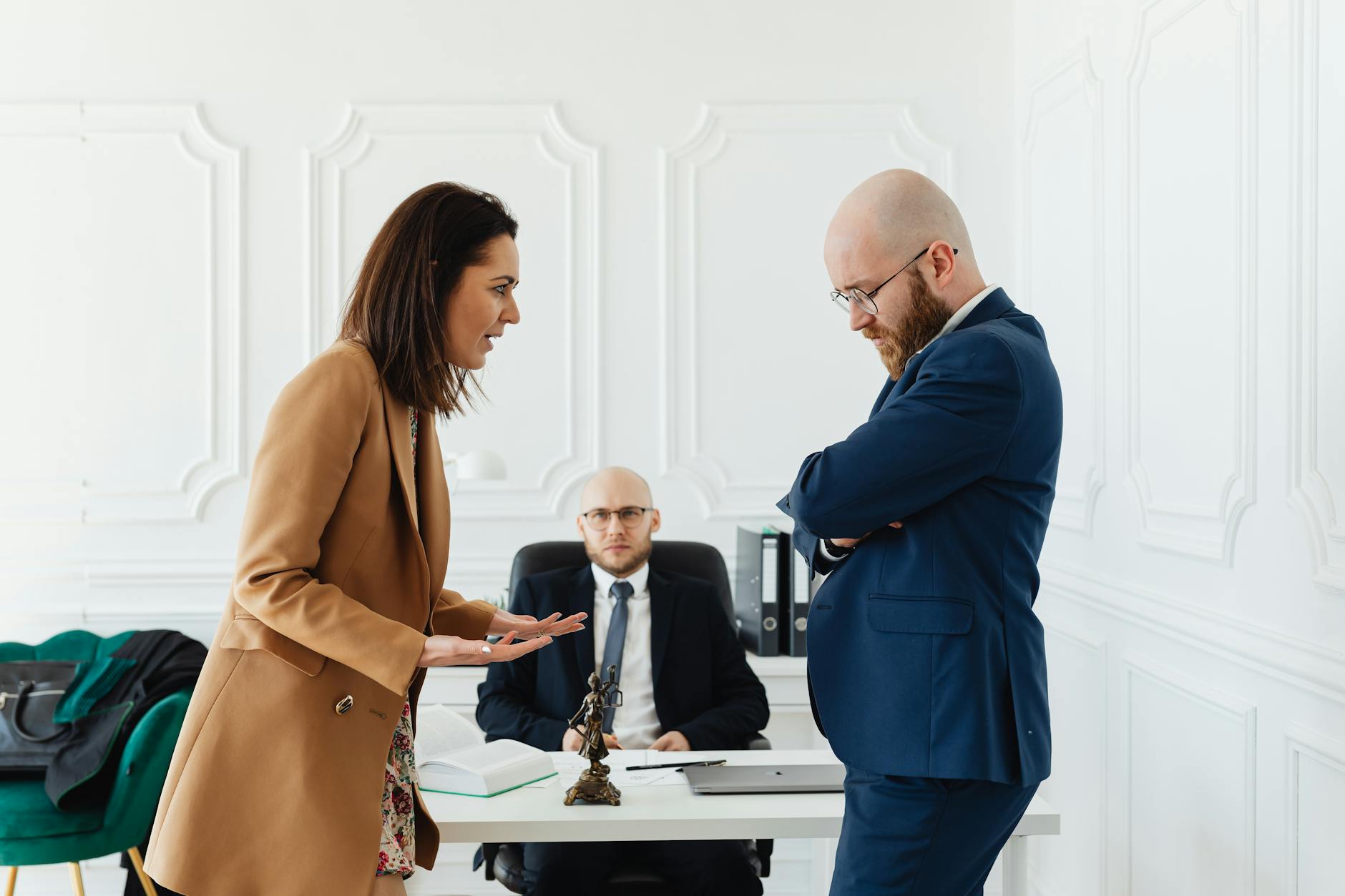 Business professionals engaged in a serious office meeting discussing legal matters. - family conflict resolution strategies