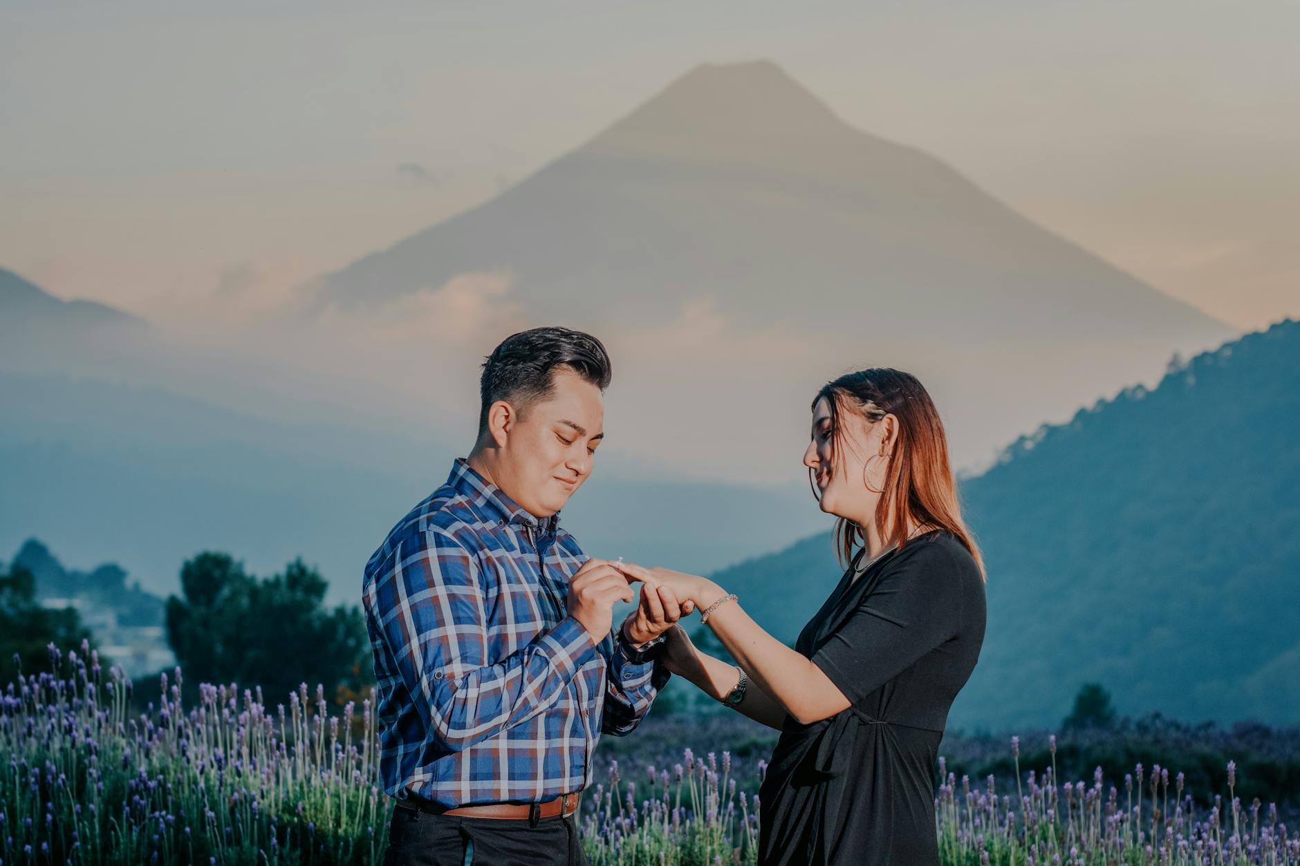 A man proposing to a woman in a picturesque lavender field with mountains in the background. - fear of commitment new relationship