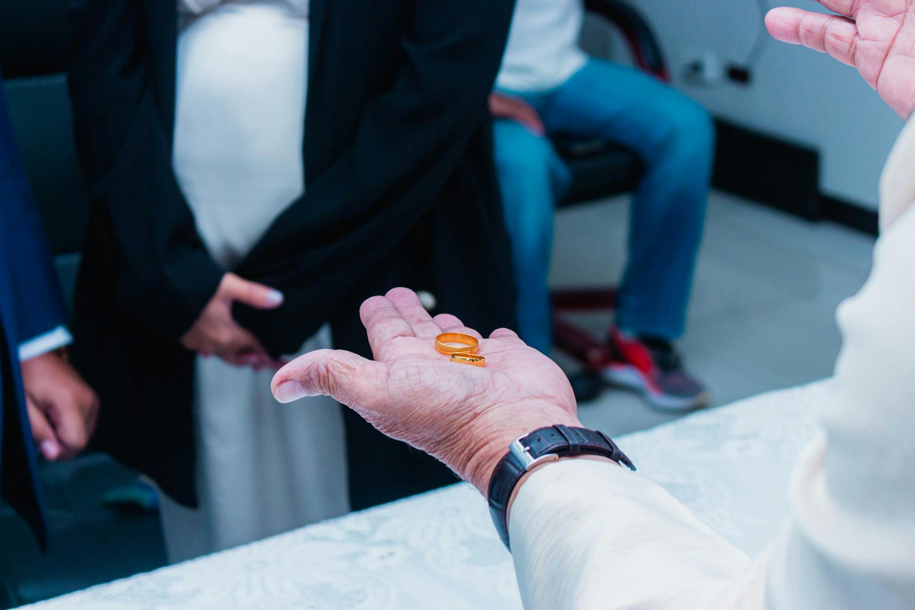 Close-up of rings on a groom's hand during a wedding ceremony indoors. - fear of commitment new relationship