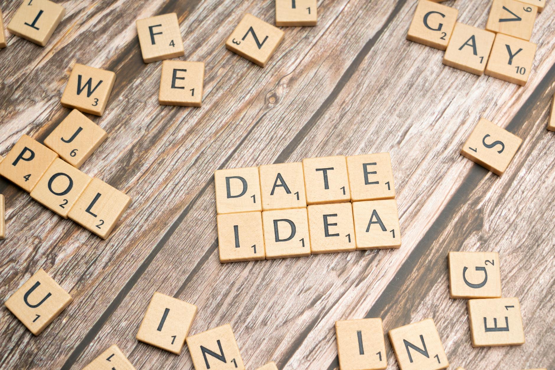 Letter tiles spelling 'Date Idea' on a wooden surface, suggesting creative meeting plans. - intimate winter date ideas