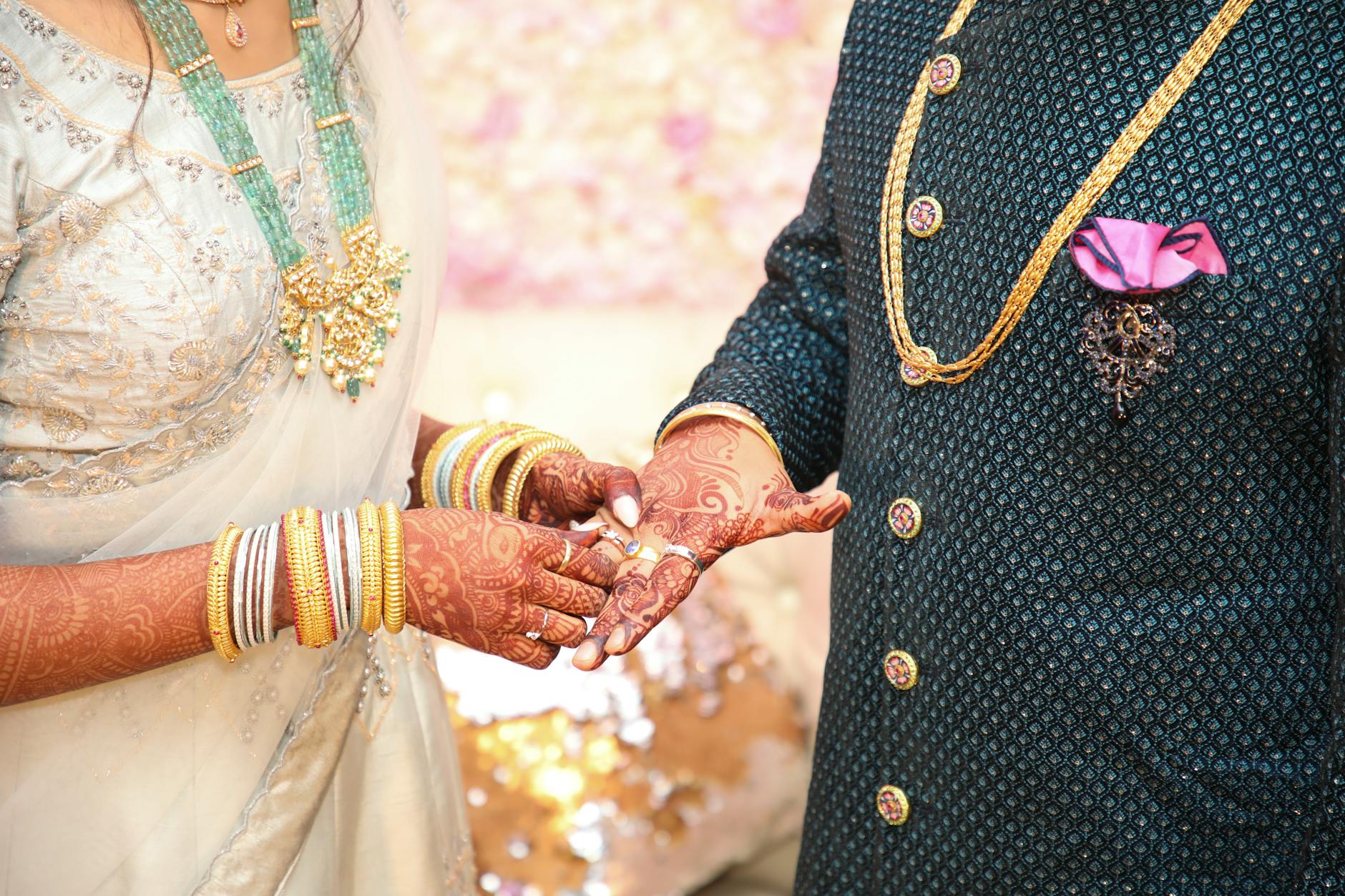 Beautiful moment of a traditional Indian wedding ceremony with stunning jewelry and henna-adorned hands. - marriage advice for newlyweds