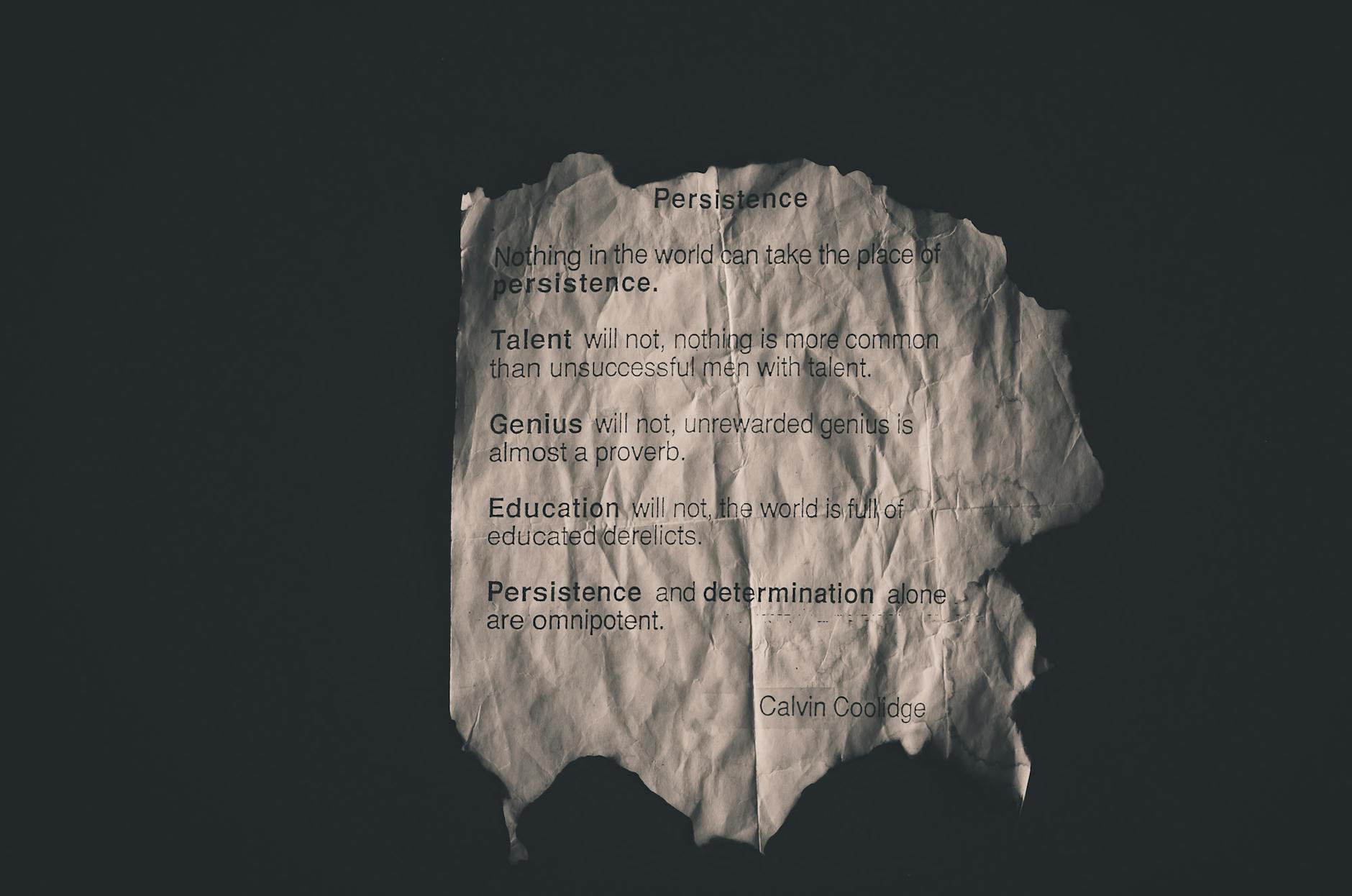 Calvin Coolidge quote on perseverance printed on crumpled paper. - marriage advice quotes