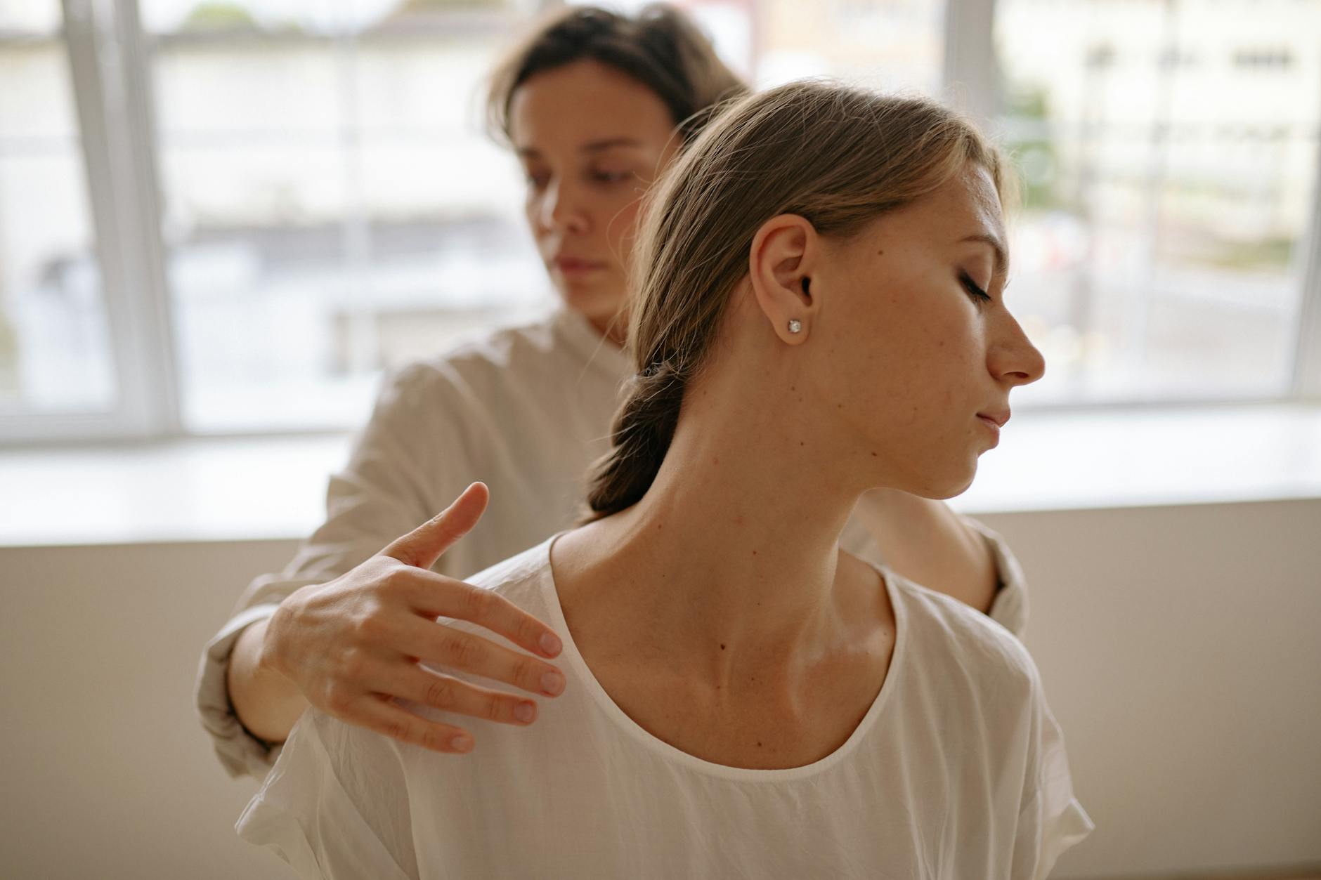 Two women engaged in a calming massage session, promoting wellness and relaxation. - mindfulness techniques financial stress