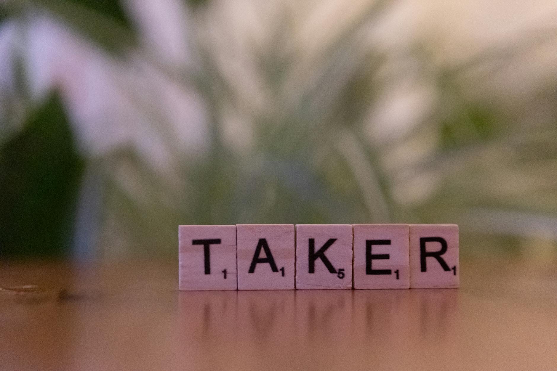 Close-up of Scrabble tiles spelling 'taker' on a blurred background, focus on letters. - narcissistic relationship signs