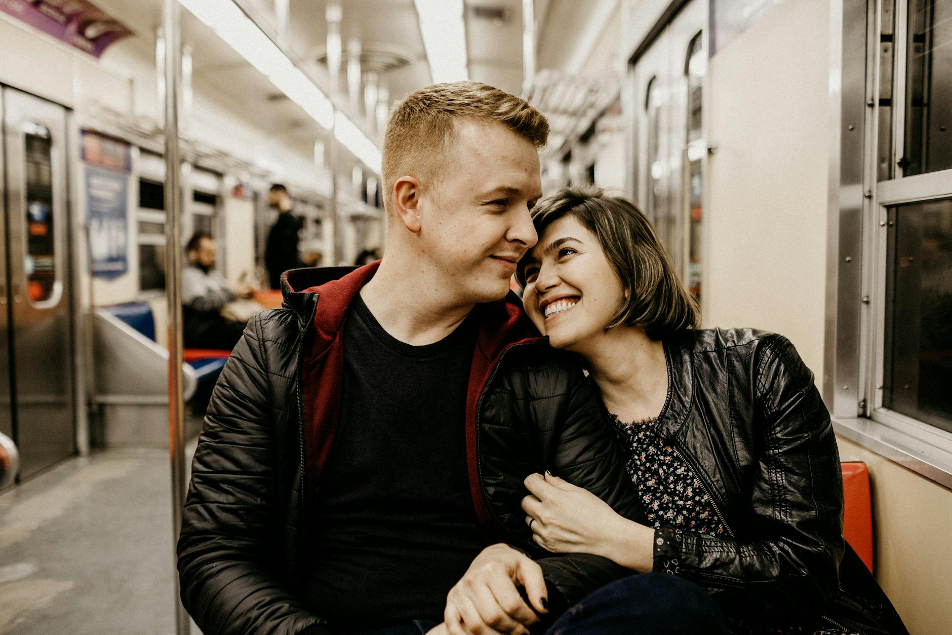 Young couple sharing a tender moment together on a train journey. - how to overcome jealousy in relationships
