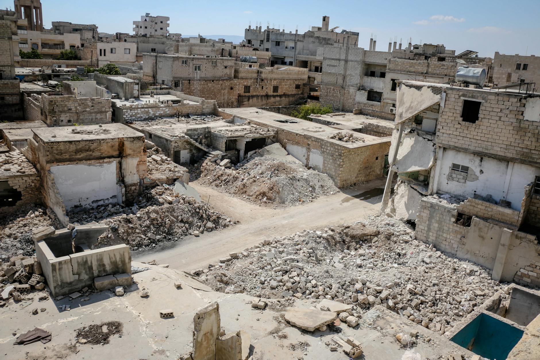 Aerial view of war-torn buildings and rubble in Idlib, Syria, highlighting urban destruction. - rebuilding trust in marriage