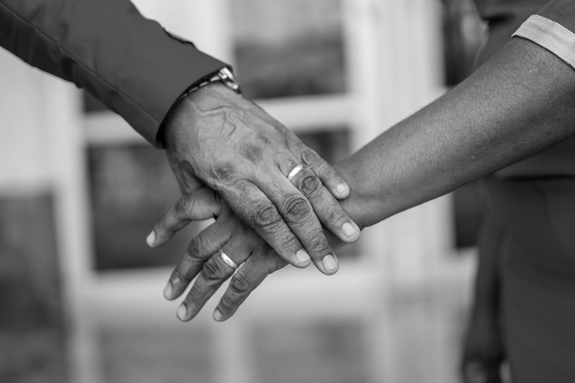 A black and white close-up of hands wearing wedding rings, symbolizing love and commitment. - rebuilding trust in marriage