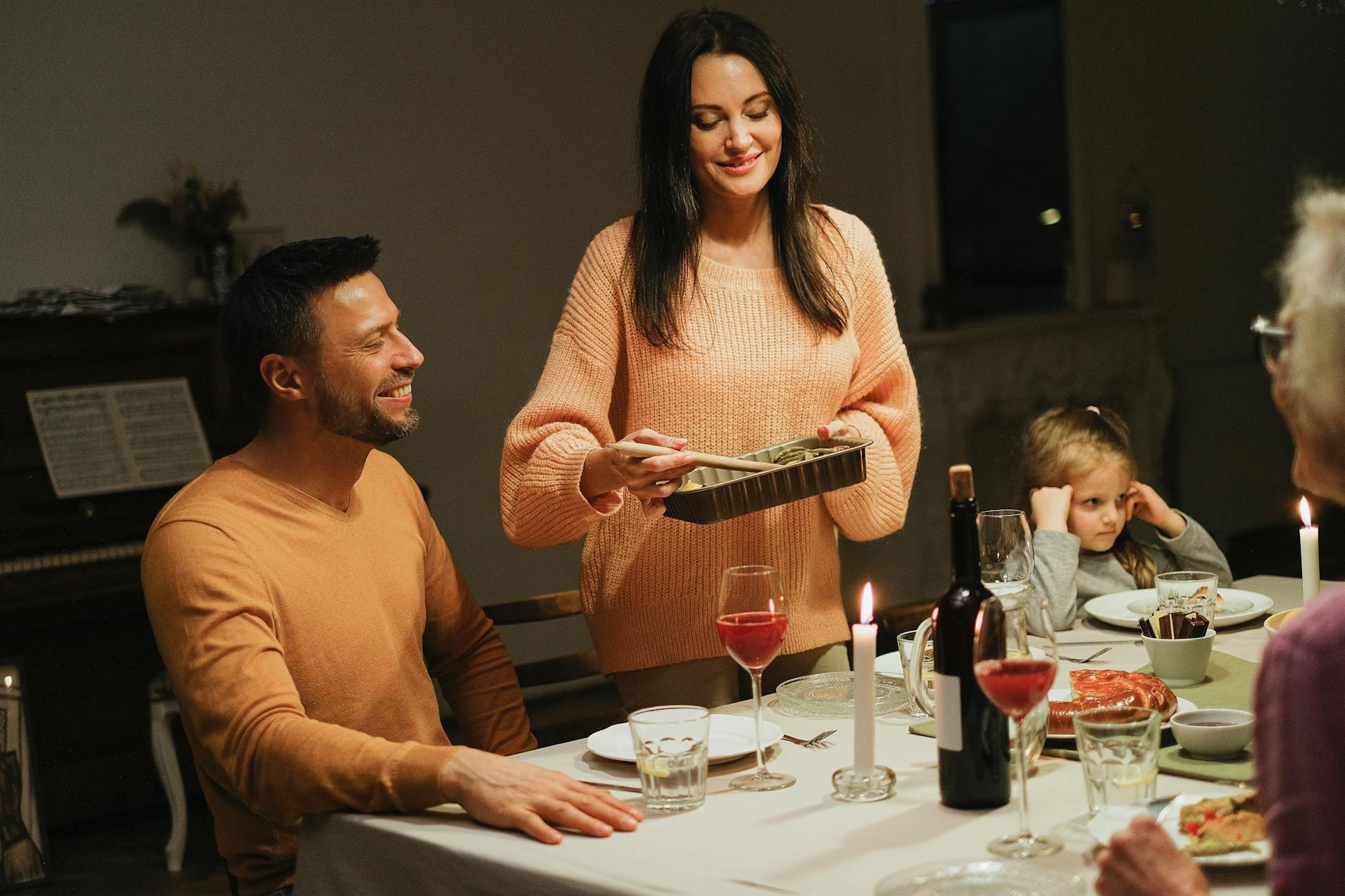 Warm family dinner with candles and wine, perfect for intimate home gatherings. - setting boundaries family gatherings