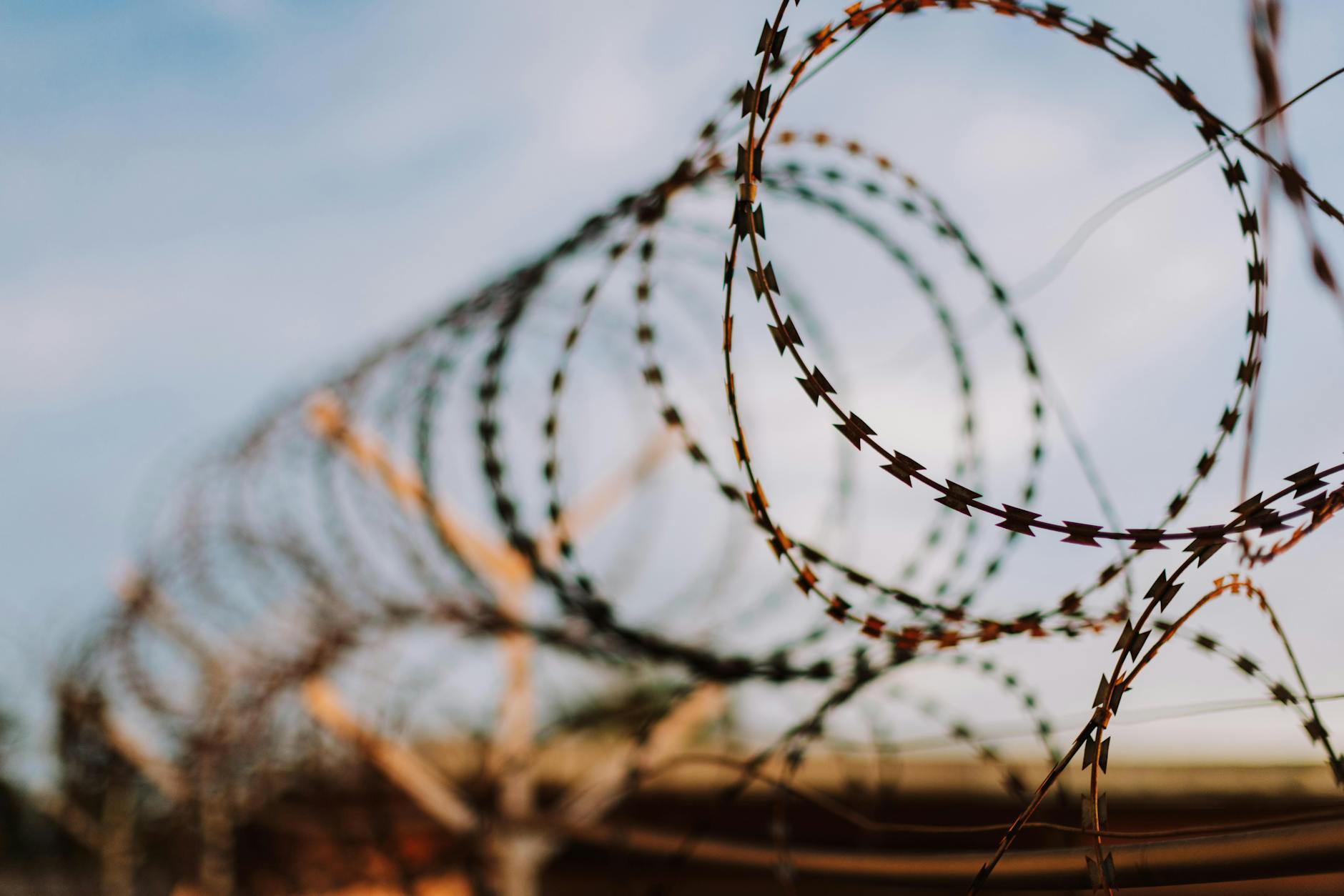 Detailed close-up of barbed wire with a blurred background, emphasizing sharpness. - setting boundaries holidays